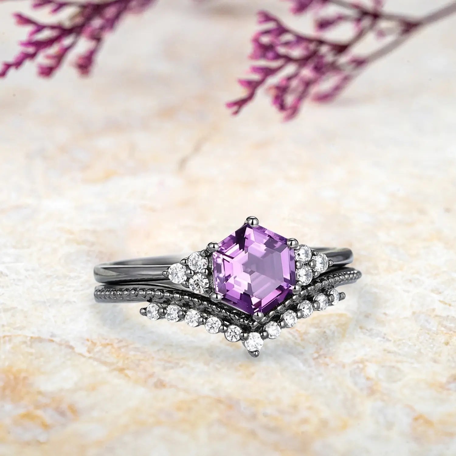 Side view of hexagon amethyst ring showing three stone cluster design and milgrain chevron wedding band profile