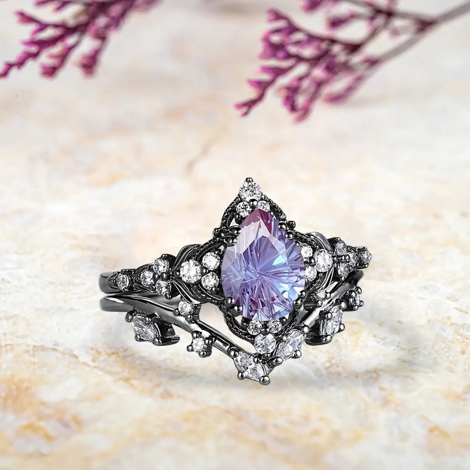 Side view of pear alexandrite fireworks ring showing leaf inspired cluster halo and curved chevron wedding band profile