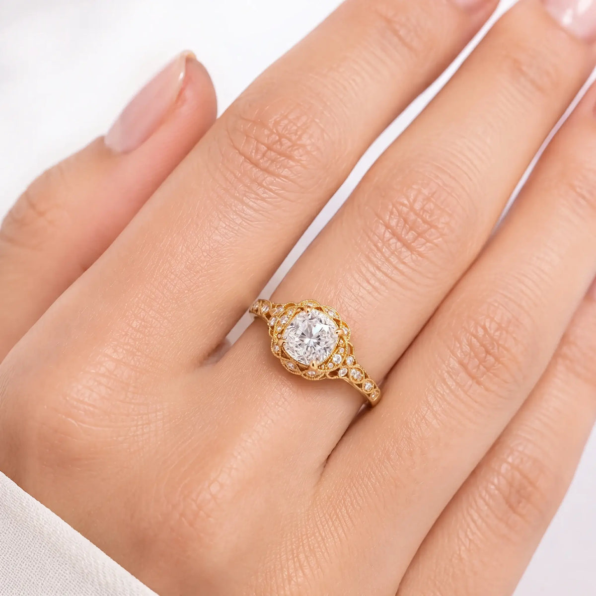 Openwork vintage moissanite halo ring with antique milgrain craftsmanship on hand