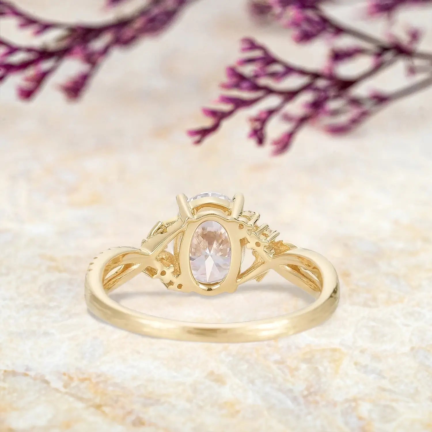 Woman wearing oval moissanite yellow gold engagement ring with tree bark texture