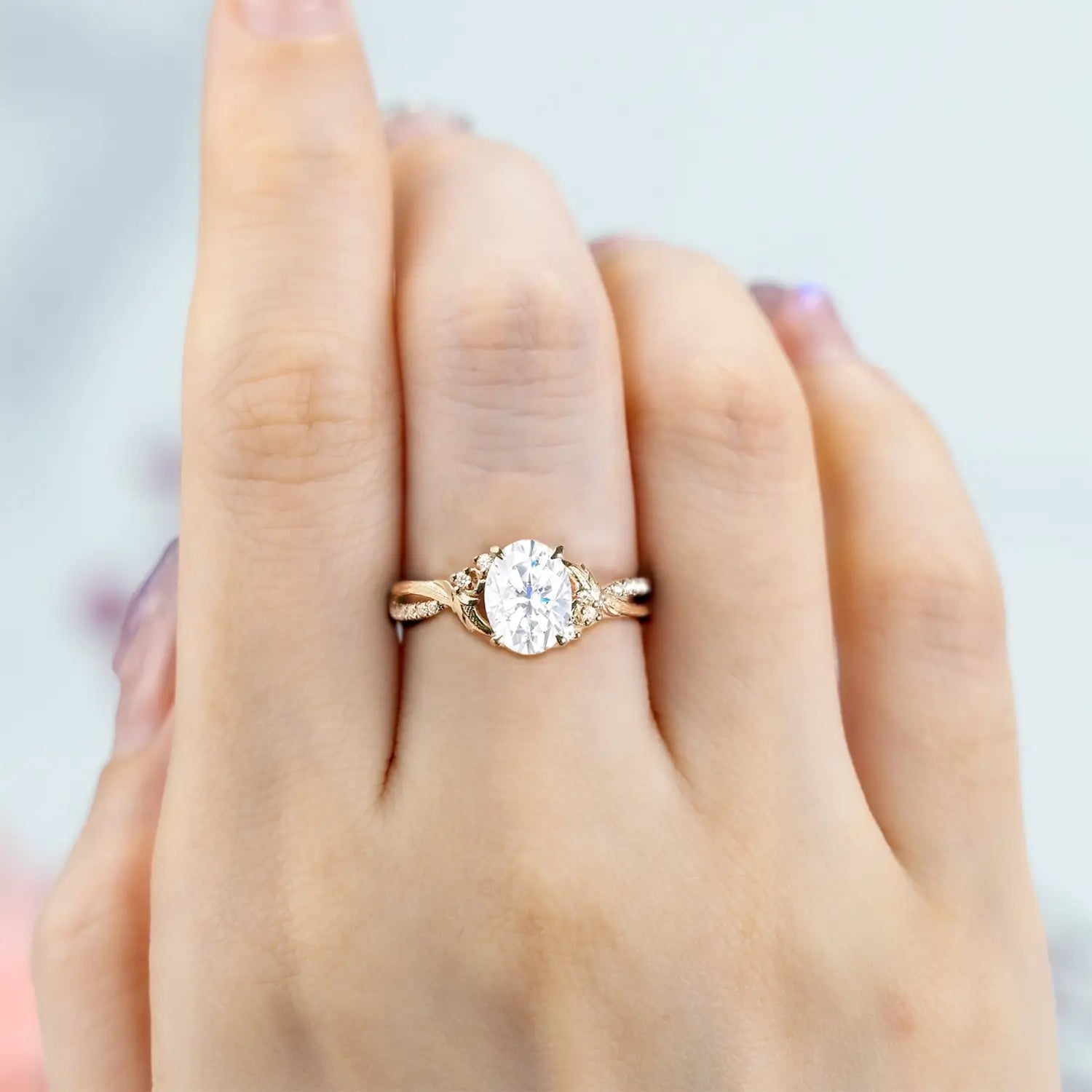 Side view of moissanite ring showing yellow gold tree bark texture and leaf details