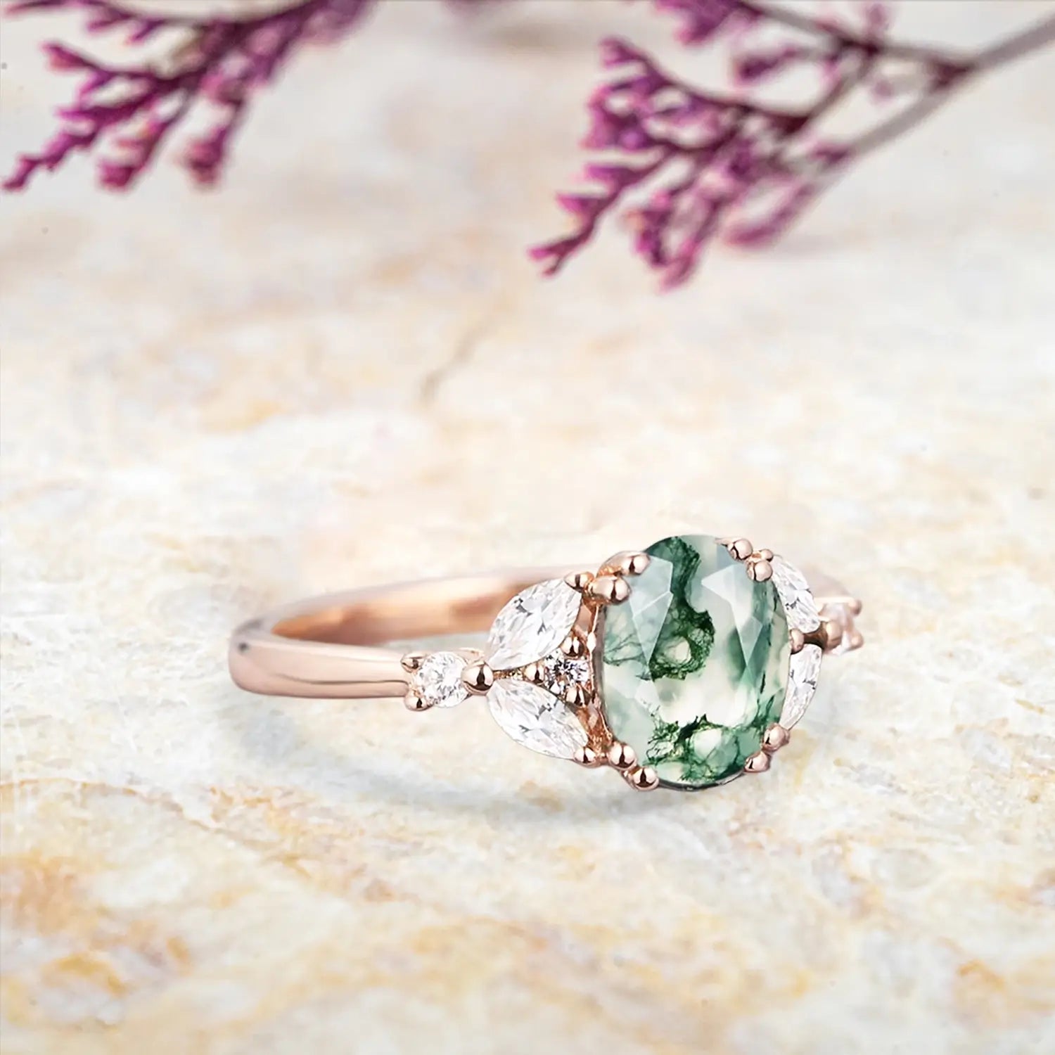 Side view of moss agate cluster ring showing rose gold band and pear stone details