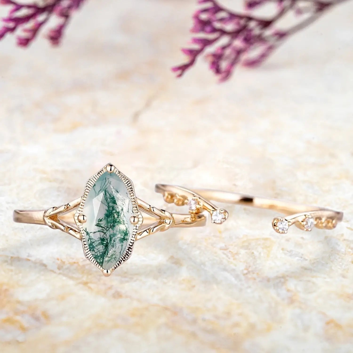 Marquise moss agate split shank engagement ring and open curved wedding band displayed separately showing vintage nature inspired set