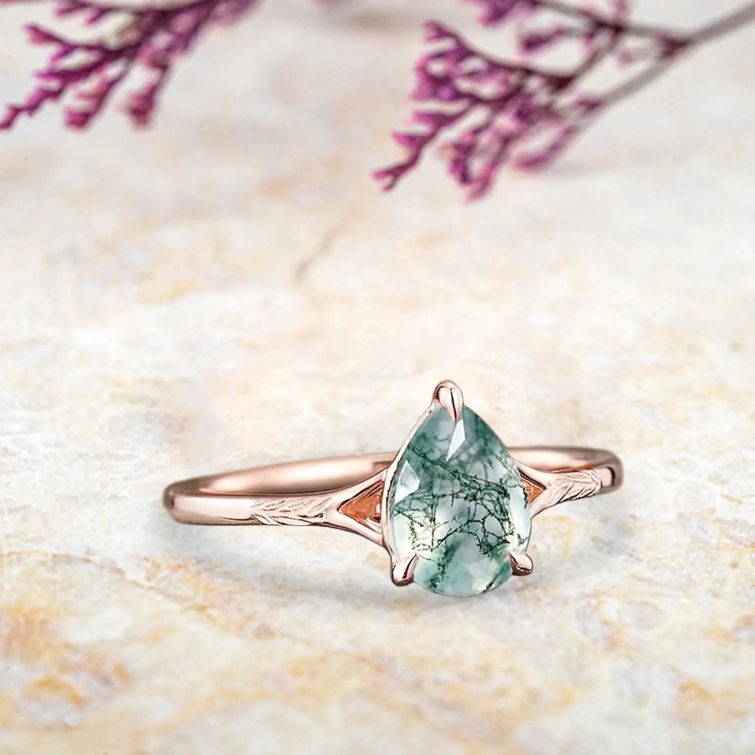 Side view of pear moss agate ring showing rose gold leaf engravings and solitaire setting