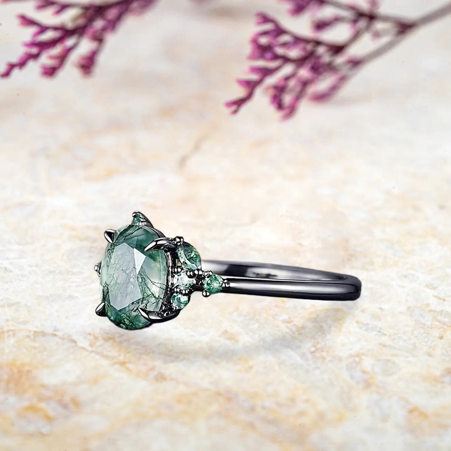 Side view of Gothic moss agate ring showing black gold band and claw prong details