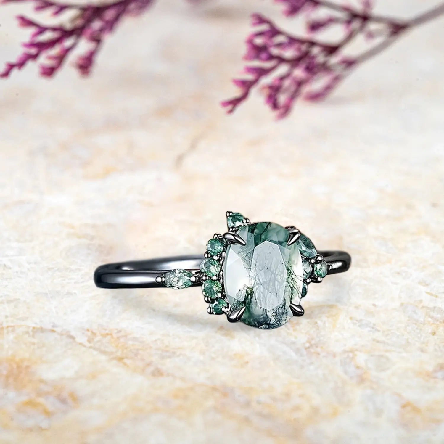 Side view of Gothic moss agate ring showing black gold band and claw prong details