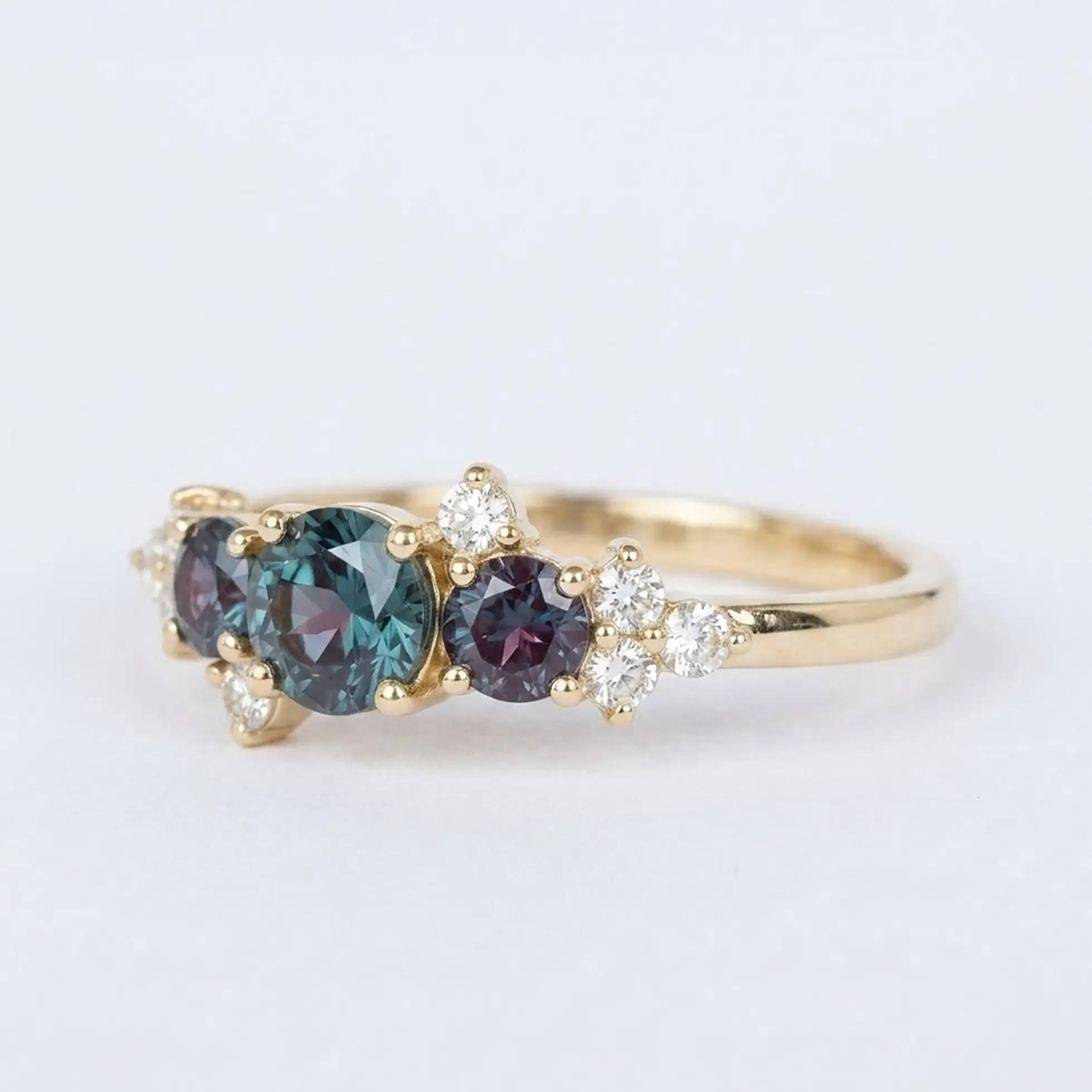 Artisanal gold ring featuring round alexandrite three stone design and geometric moissanite accent