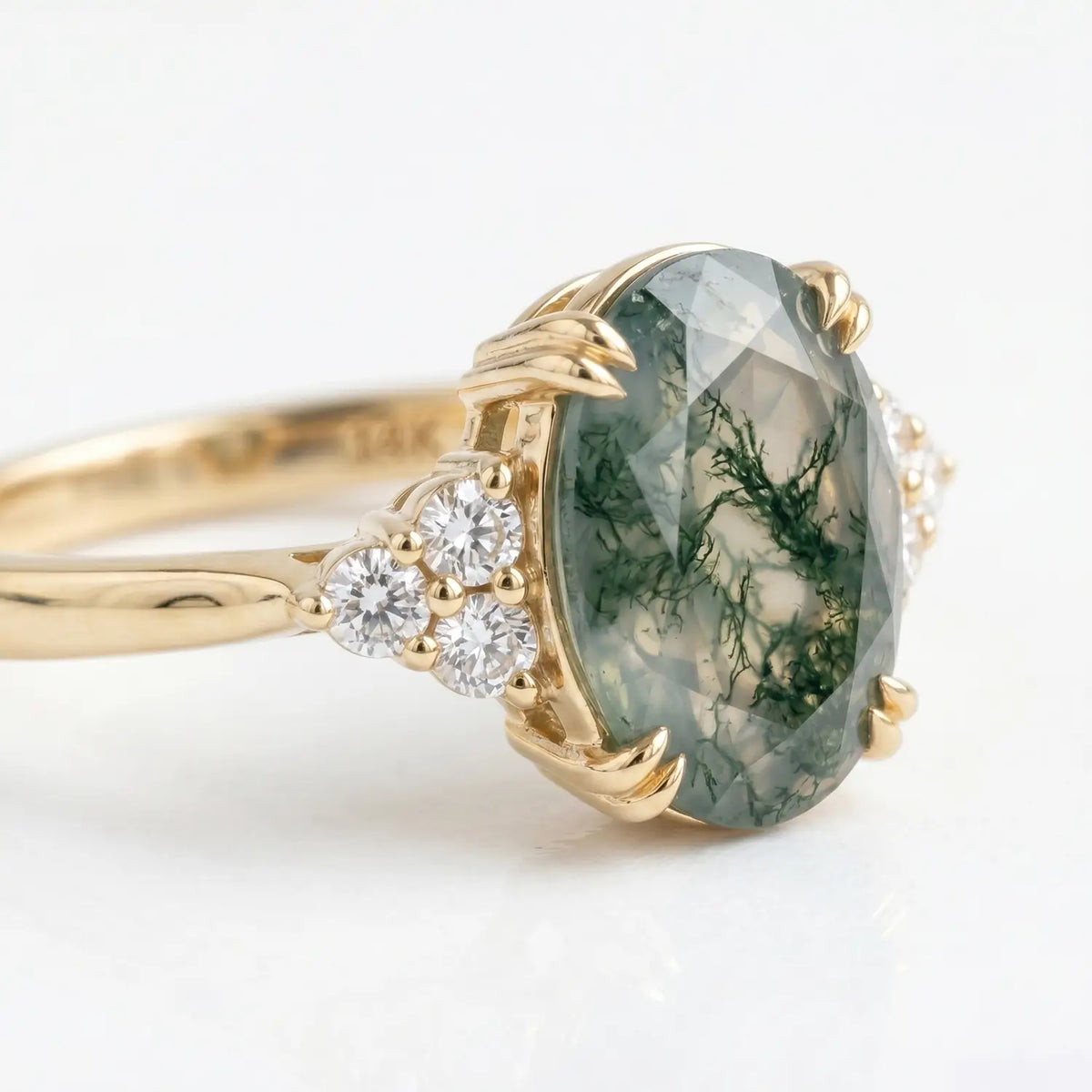 Artisanal gold cluster ring featuring moss agate with secure double eagle claw setting
