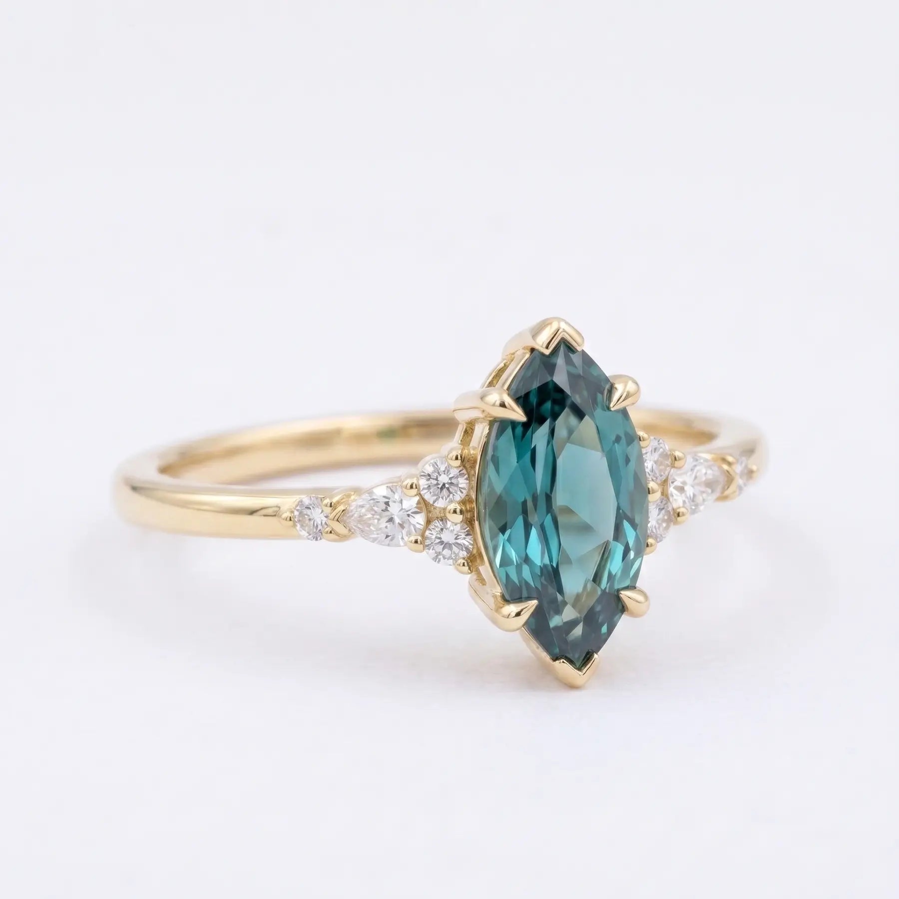 Side view of a thin solid rose gold alexandrite ring band showing low-profile cluster work and secure prongs