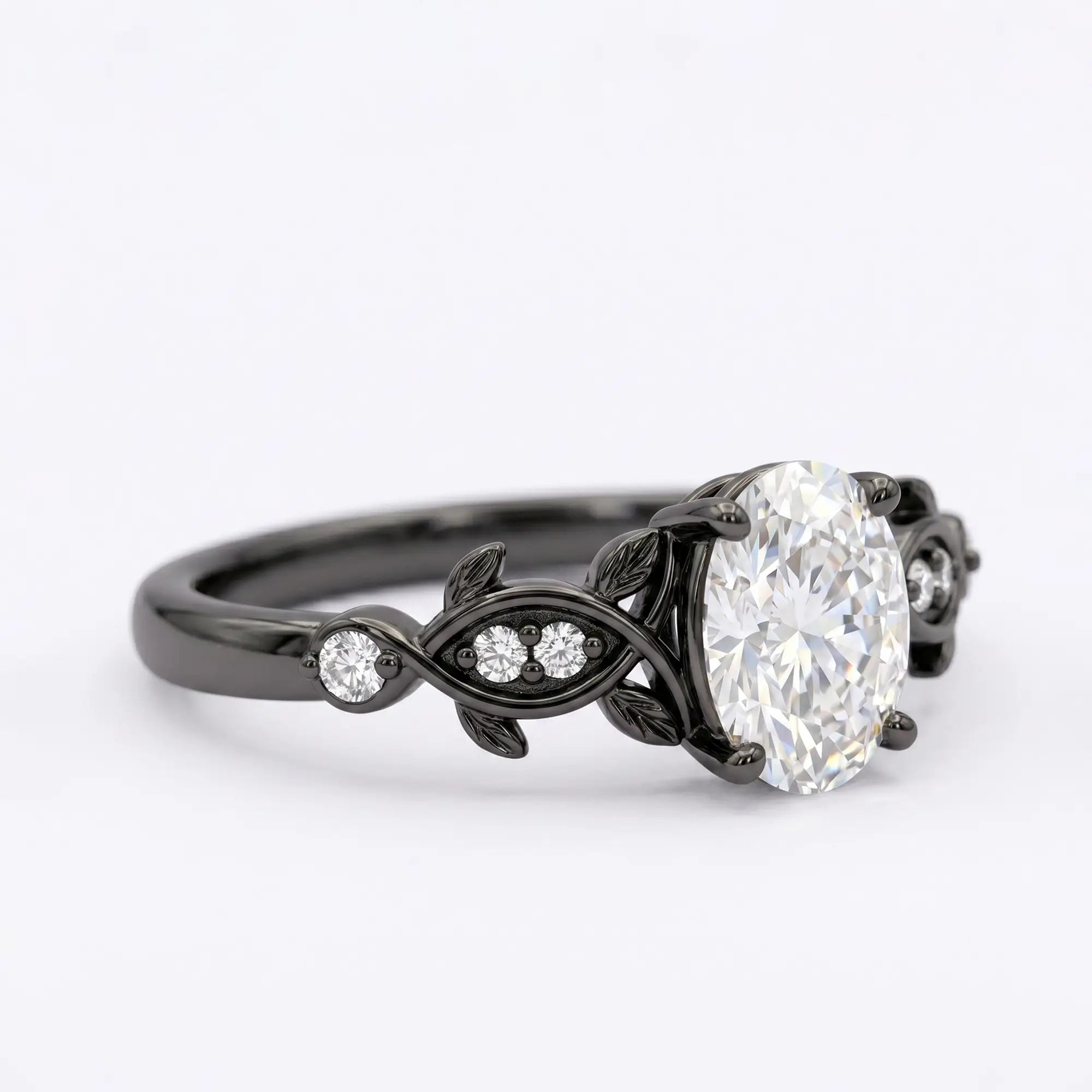 Artisanal dark gold ring featuring oval cut moissanite held by unique decorative organic black rhodium prongs