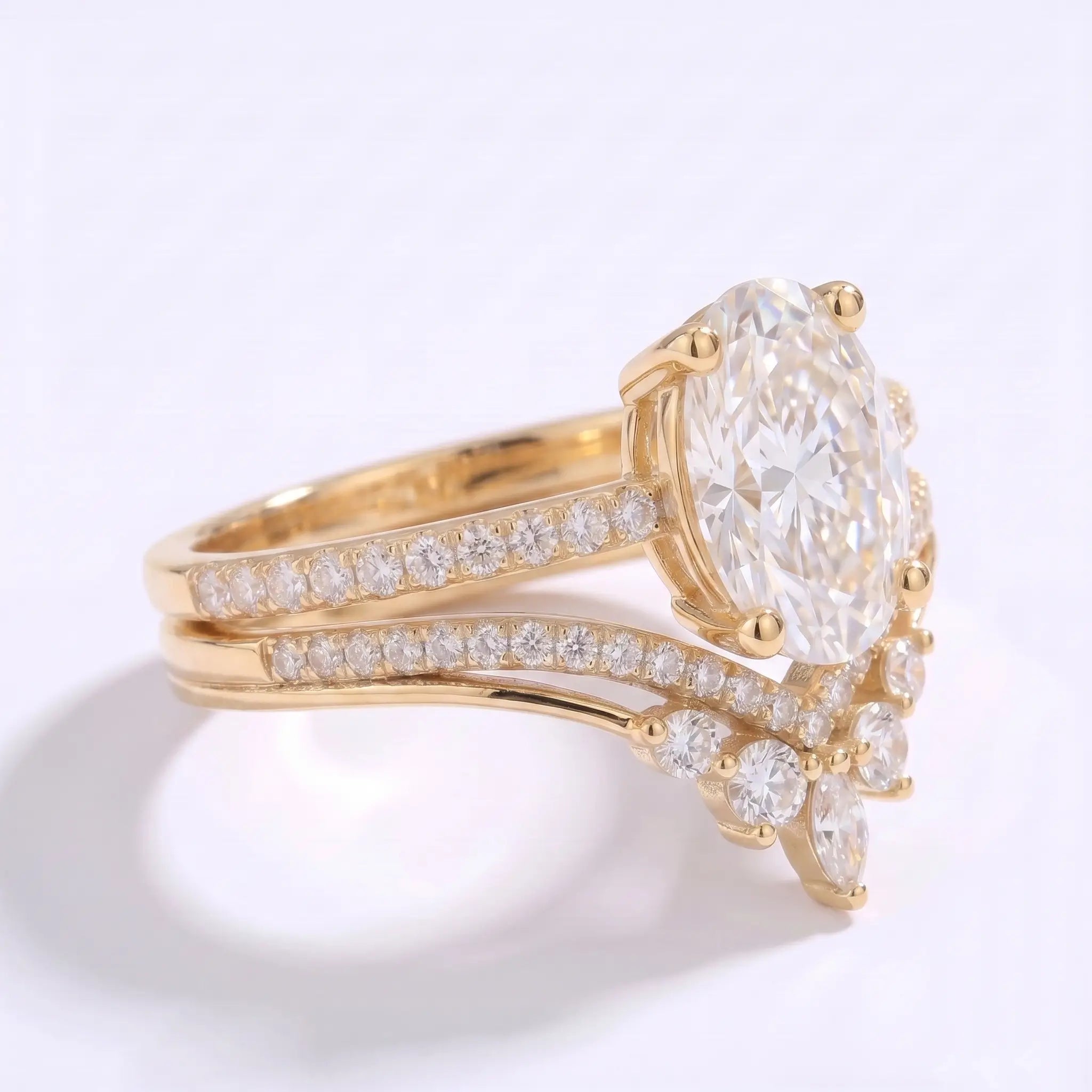 Side view of oval moissanite bridal set showing the curved nesting band and pavé details