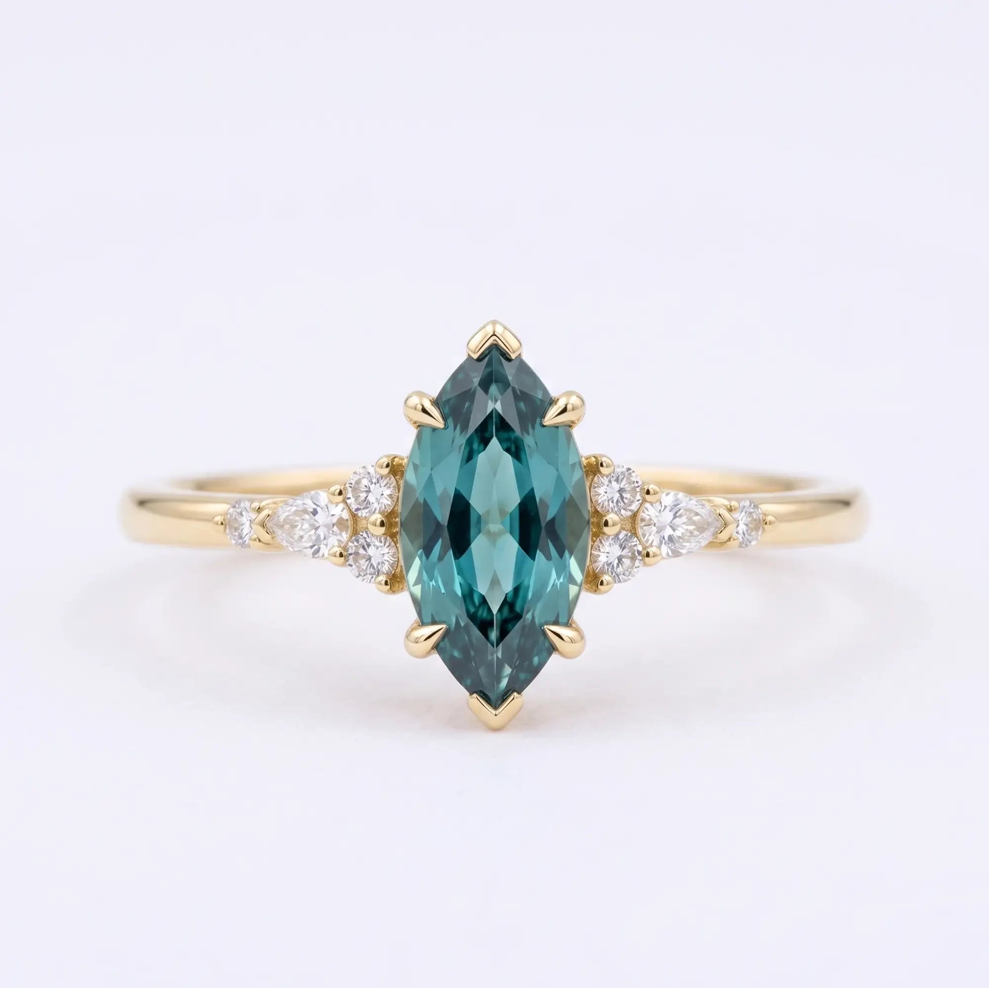 Handcrafted marquise-cut lab alexandrite cluster engagement ring in solid gold with pear and round accents by Orleone