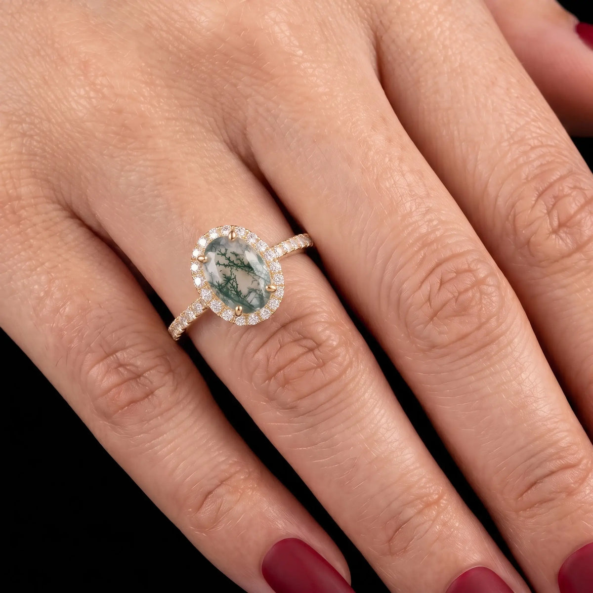 Classic moss agate halo engagement ring worn on hand