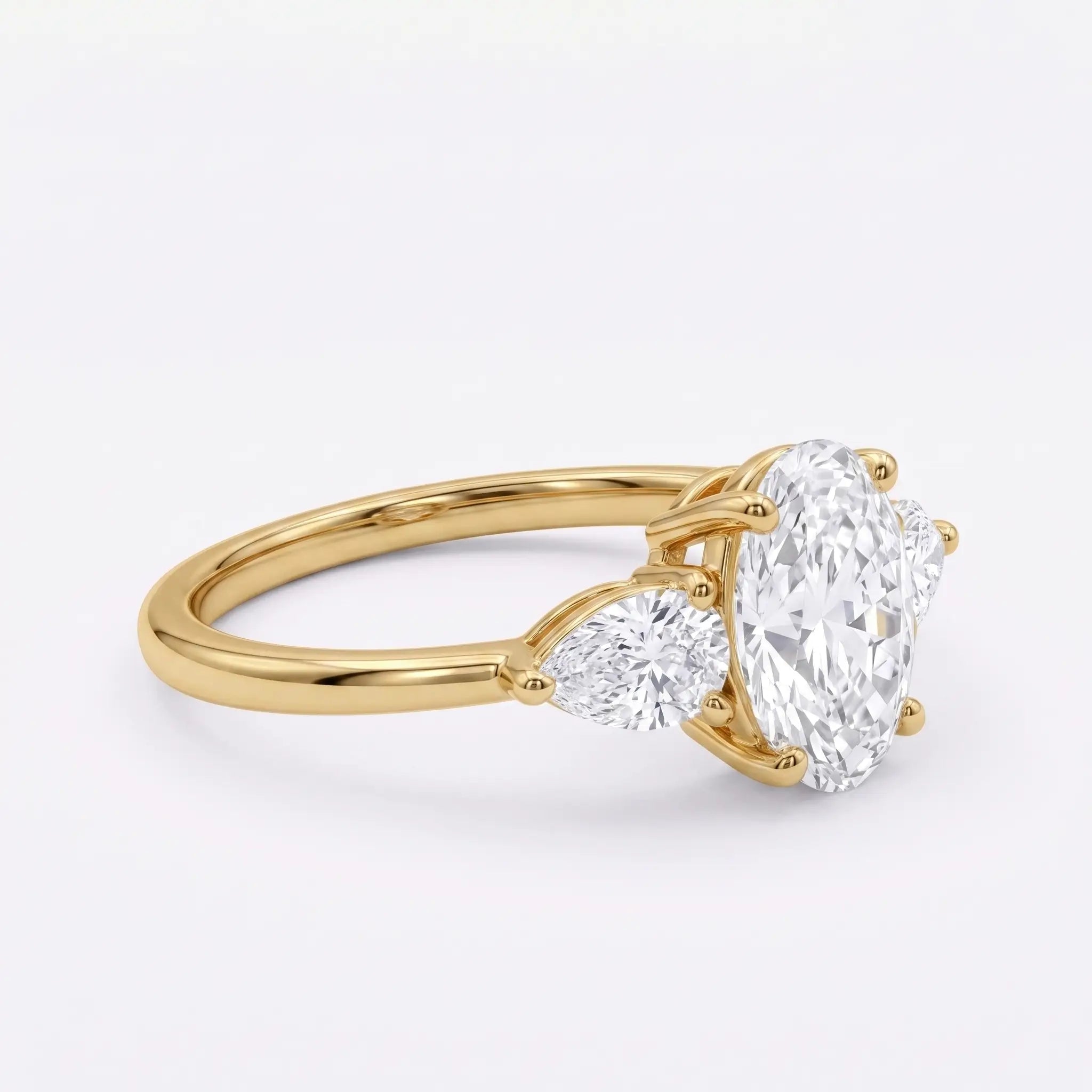 Right angle view of minimalist three stone moissanite engagement ring in gold
