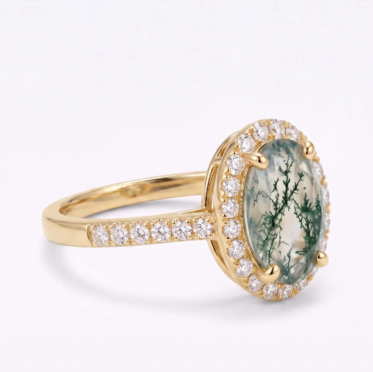 Front view of oval moss agate engagement ring with classic moissanite halo