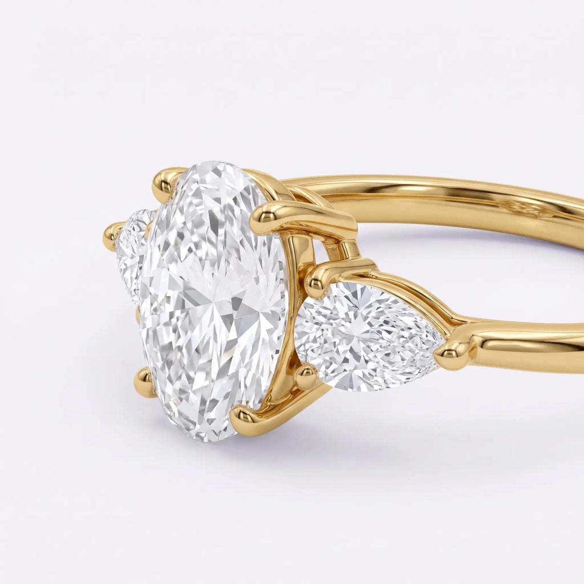 Close-up of oval moissanite center stone with two pear cut moissanite accents