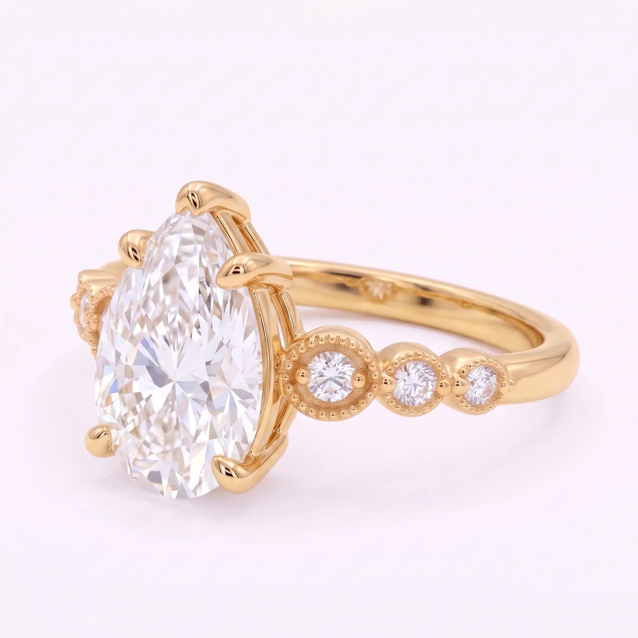 Side profile of vintage pear moissanite ring showing slim gold band and raised center setting