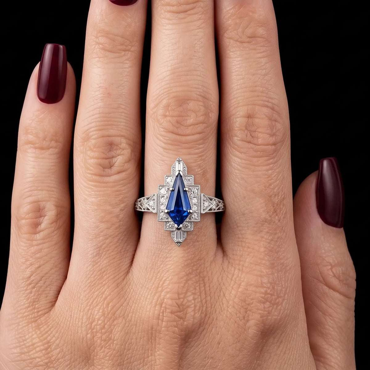 September birthstone engagement ring with kite cut lab sapphire worn on hand