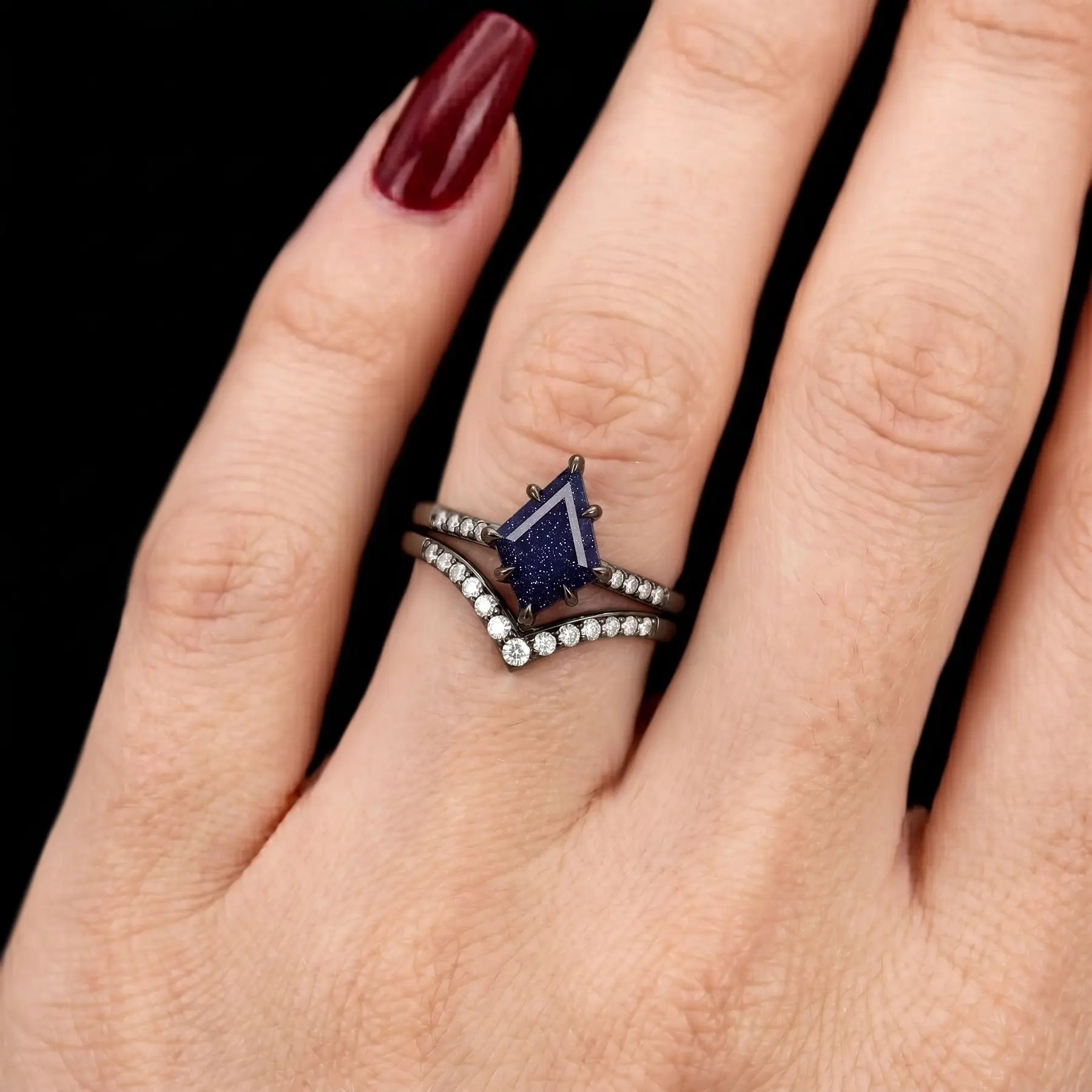 Ethereal handmade blue sandstone kite ring set on hand showing midnight galaxy sparkle and chevron band alignment