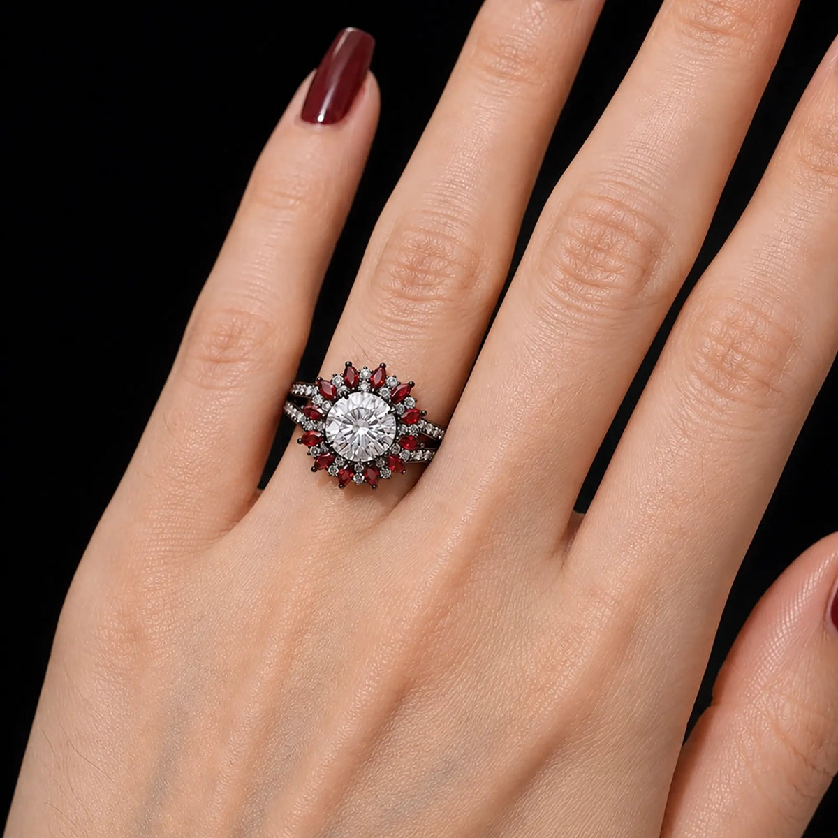 Round moissanite ruby halo ring worn on hand with bold gothic design