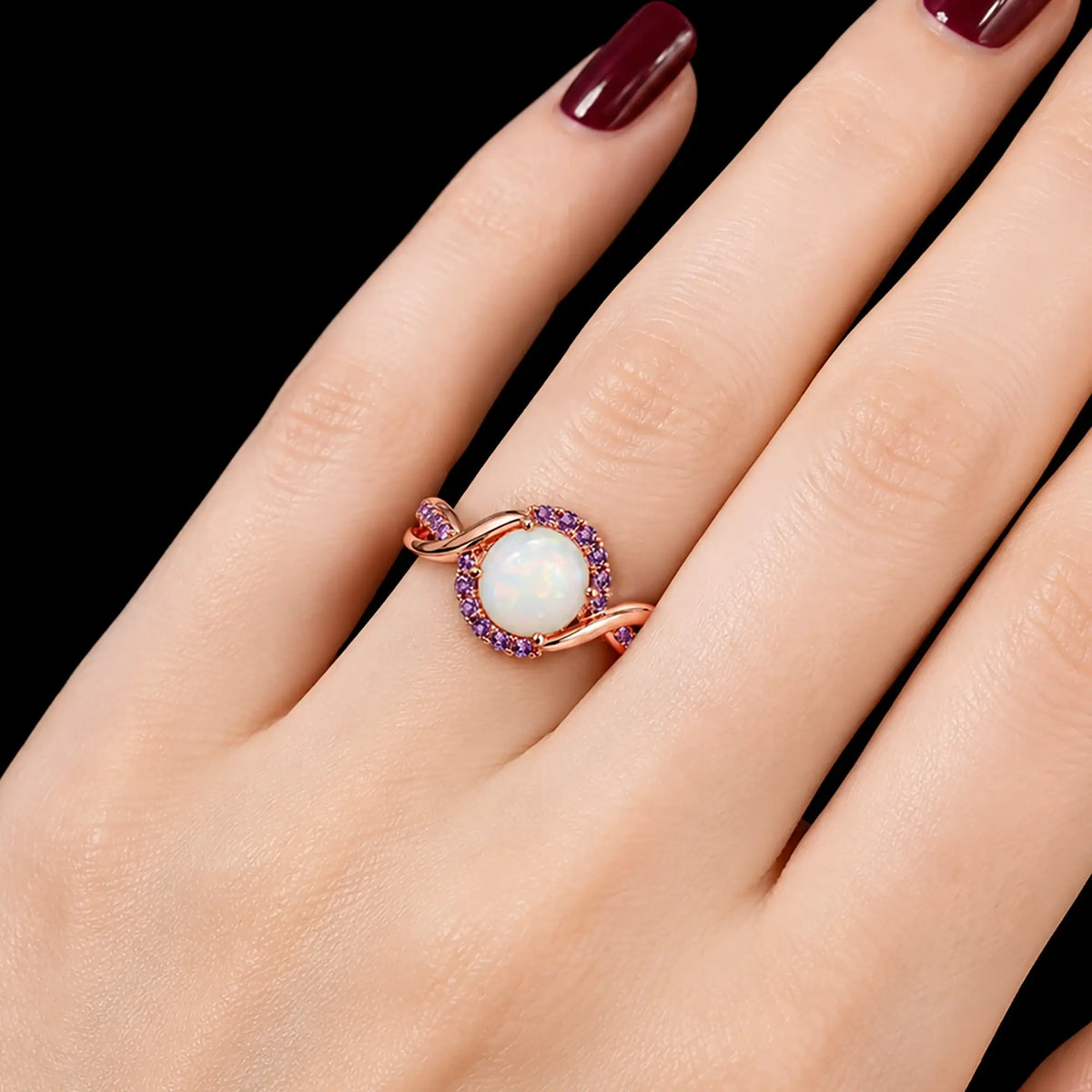 Round white opal halo ring worn on hand with classic romantic design
