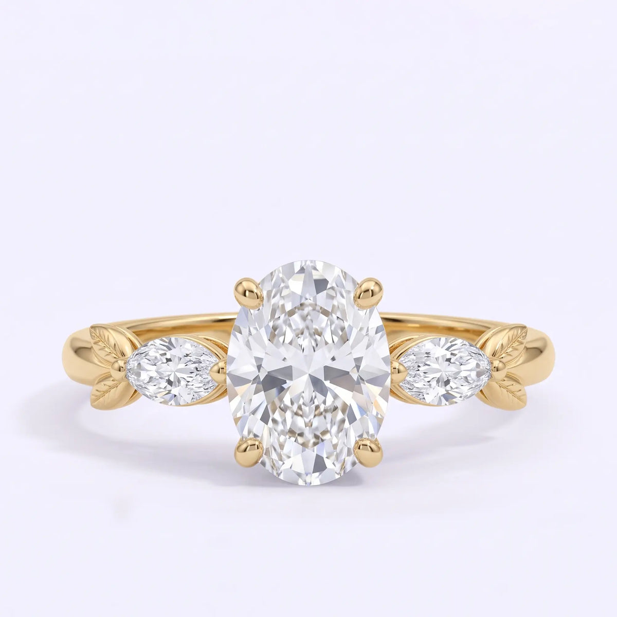 Nature inspired oval moissanite three stone engagement ring with marquise side stones and sculpted gold leaves in yellow gold