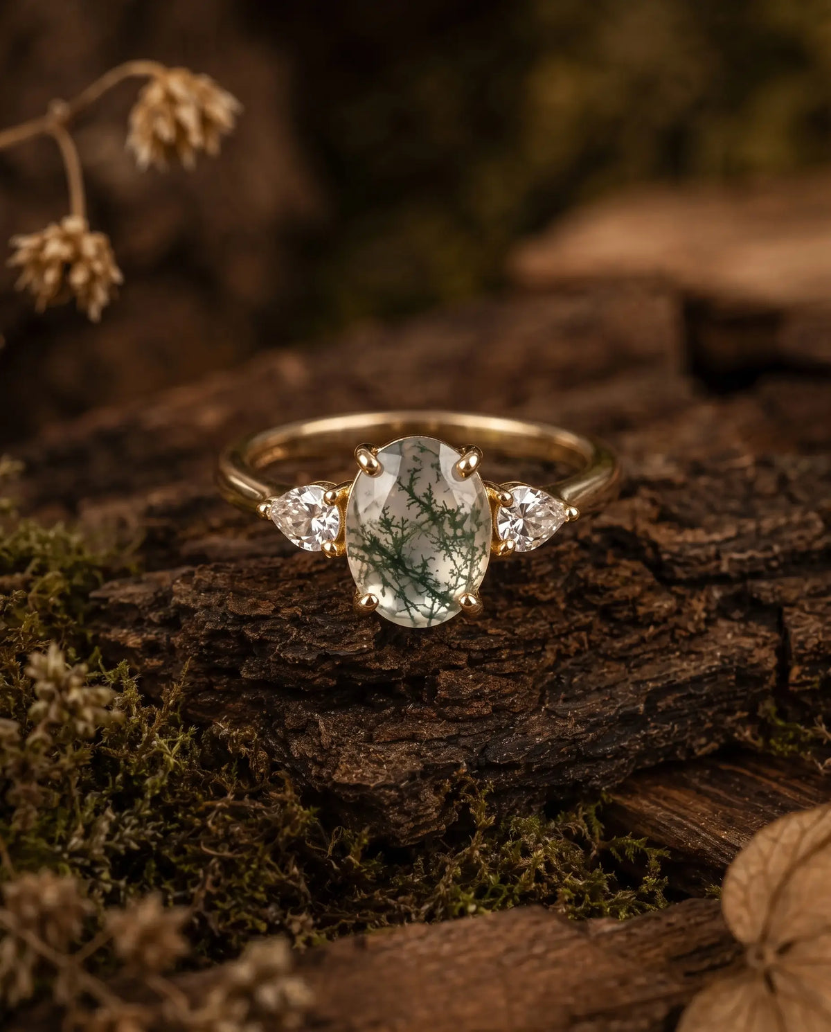 Oval moss agate three stone ring worn on hand for engagement or anniversary styling