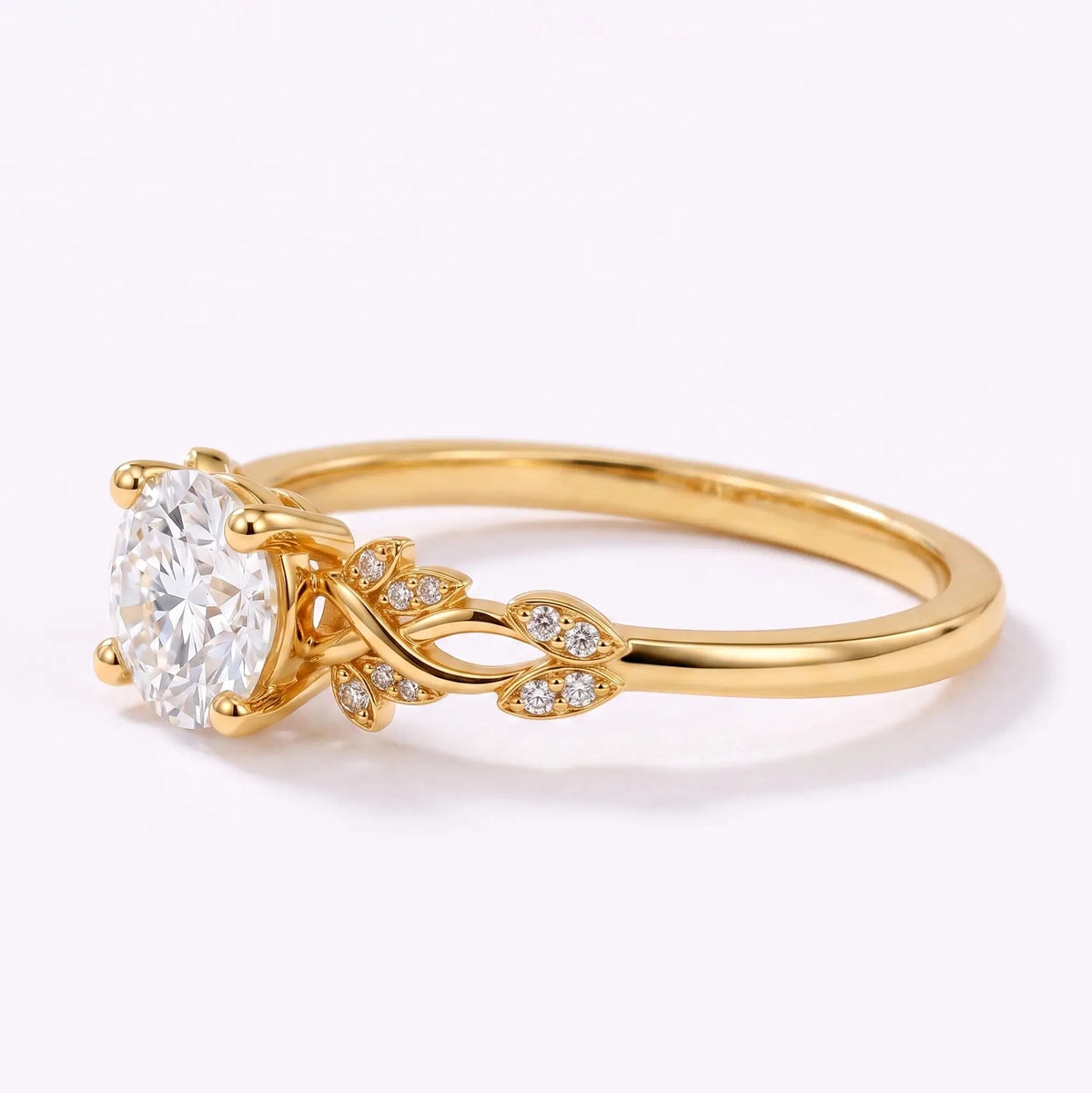 left view of botanical leaf details on a round lab diamond engagement ring
