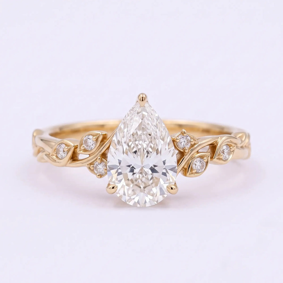 Pear cut moissanite nature inspired botanical leaf engagement ring in yellow gold