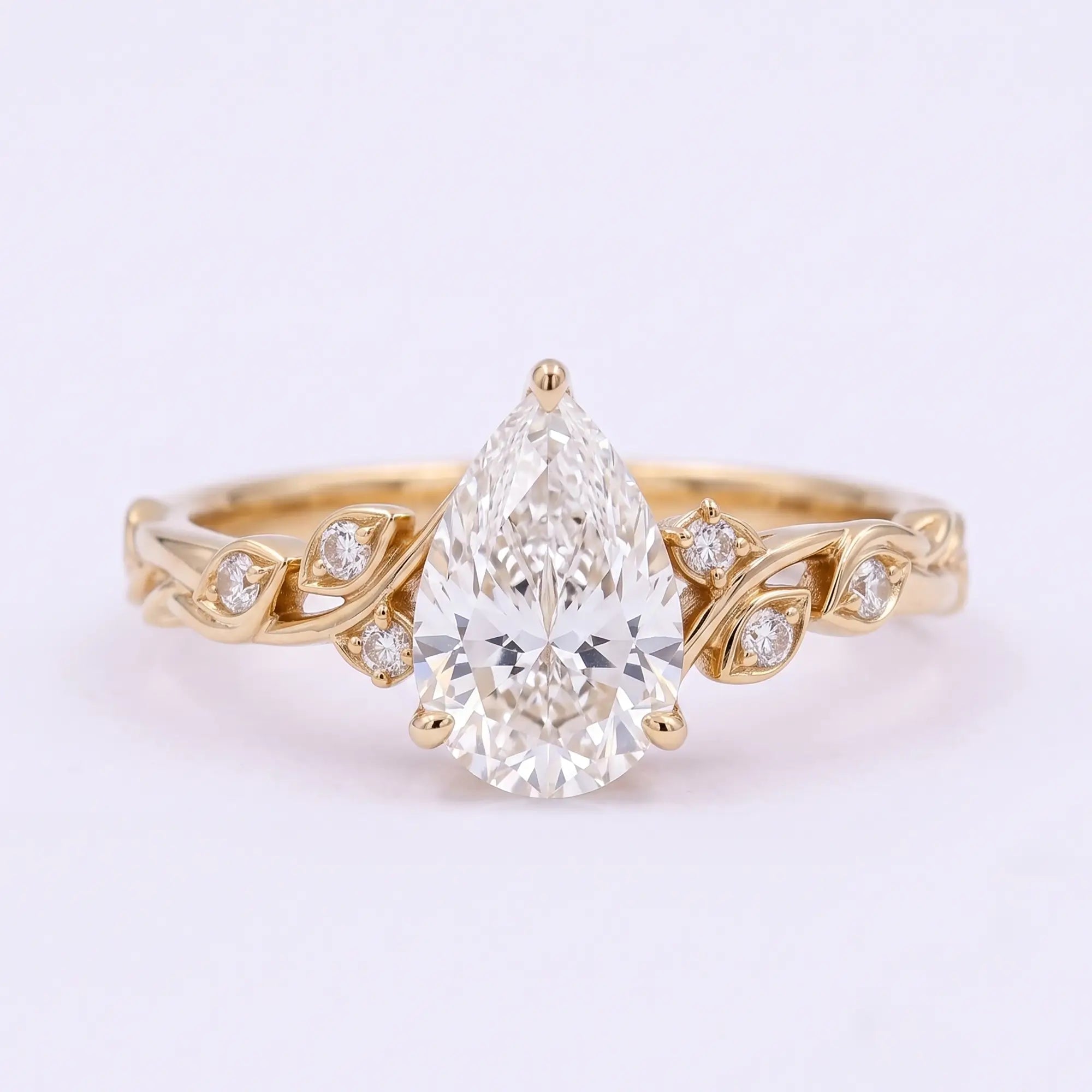 Pear cut moissanite nature inspired botanical leaf engagement ring in yellow gold