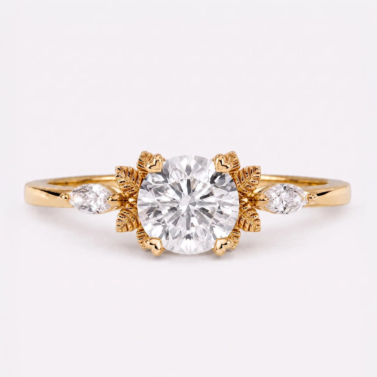 Round moissanite leaf engagement ring with marquise side stones and nature-inspired gold design