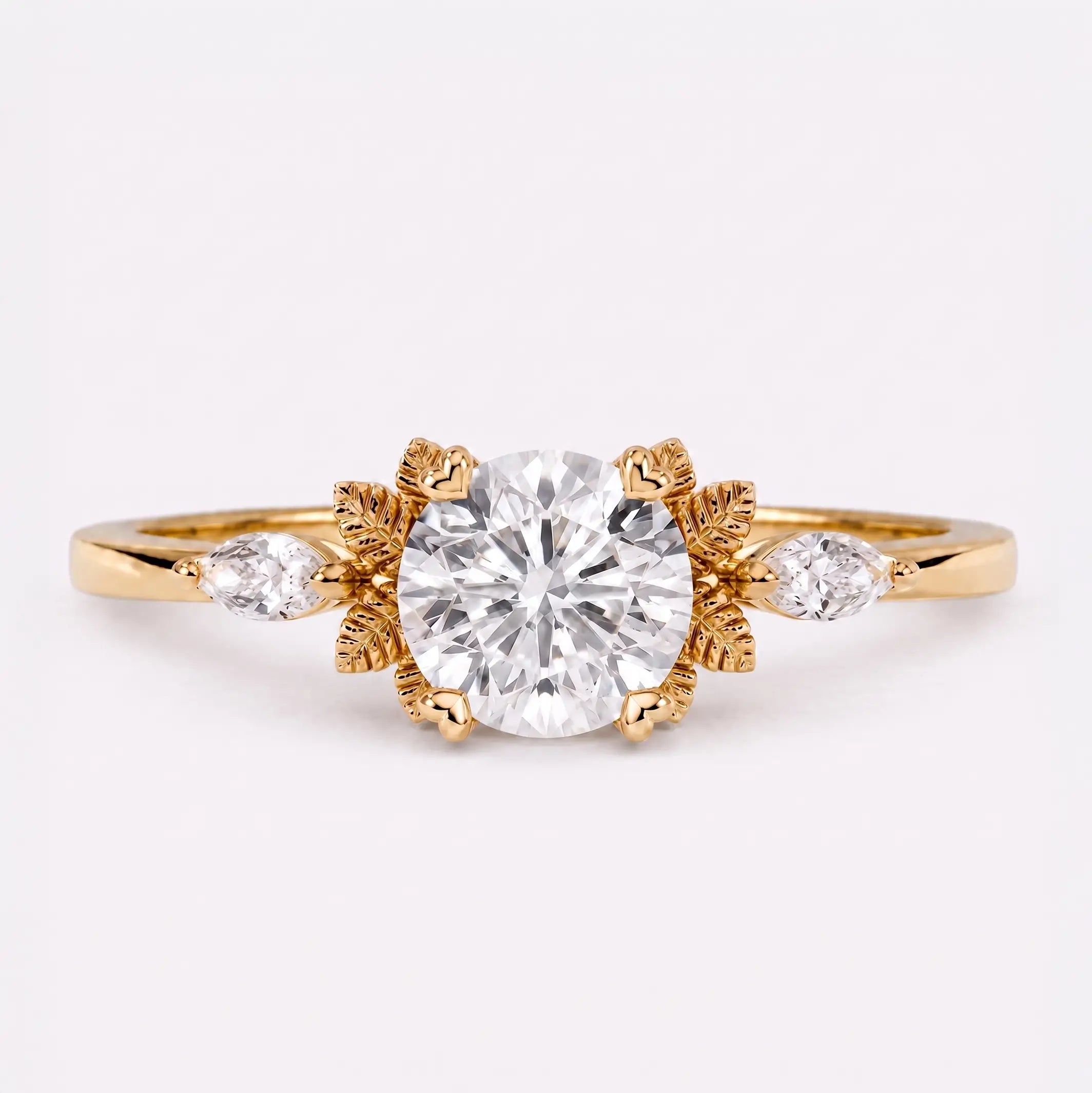 Round moissanite leaf engagement ring with marquise side stones and nature-inspired gold design