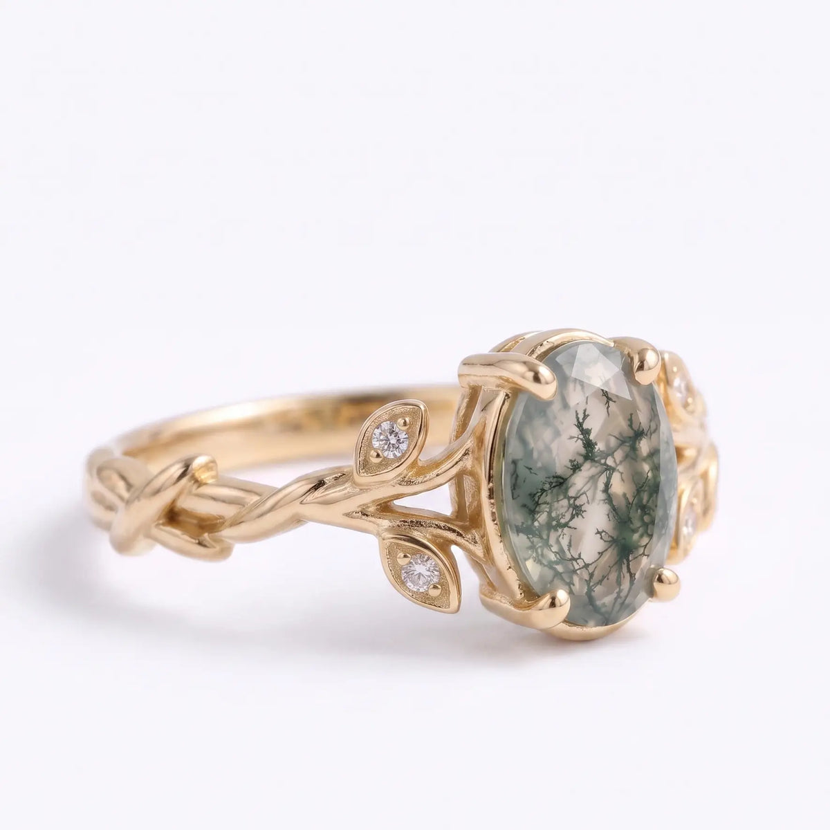 Asymmetrical leaf detail on oval moss agate engagement ring in gold