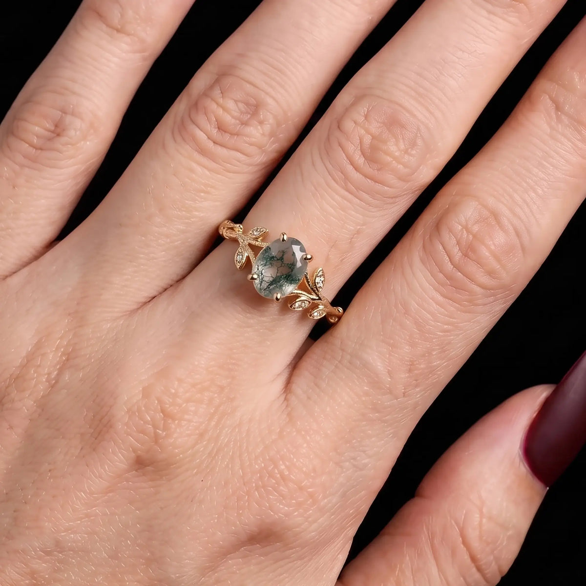 Nature inspired moss agate leaf engagement ring worn on hand