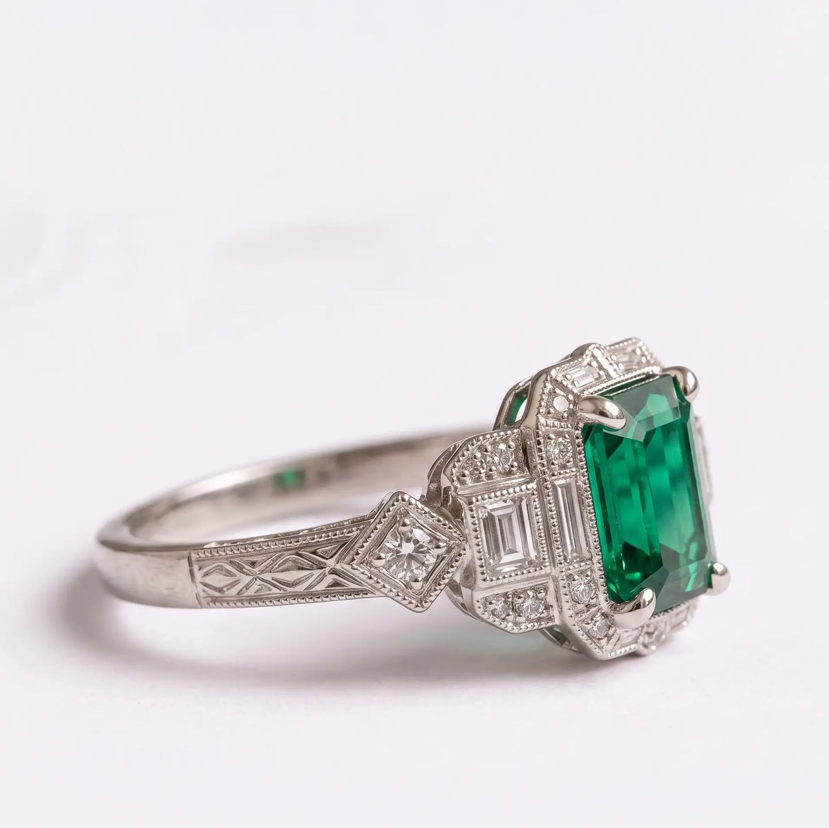 Art Deco emerald cut ring with symmetrical geometric gold setting