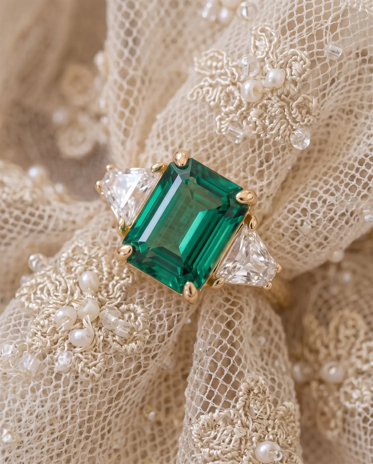 Classic emerald engagement ring styled in an elegant jewelry scene