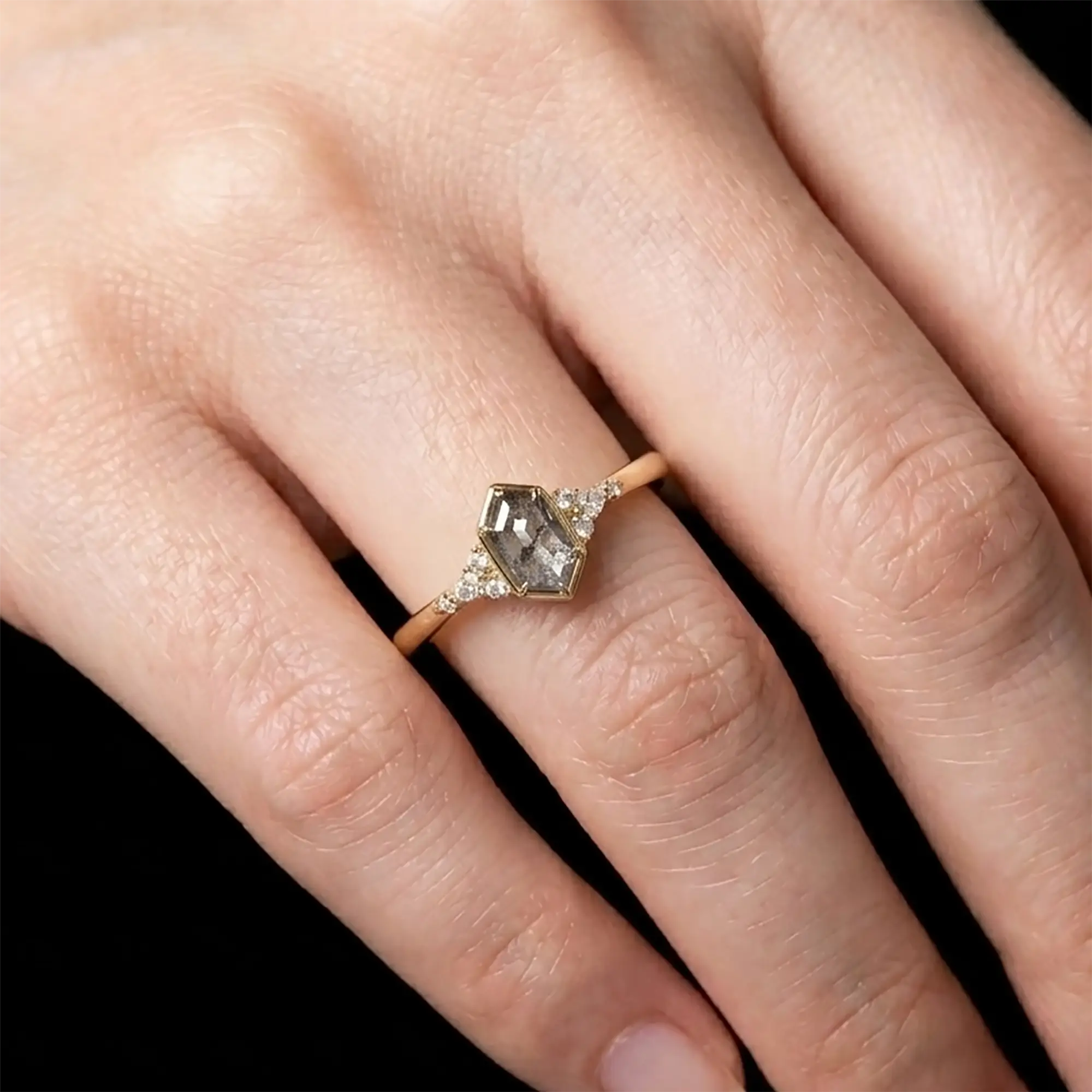Luminous handmade geometric salt and pepper diamond ring on hand showing natural smoky inclusions