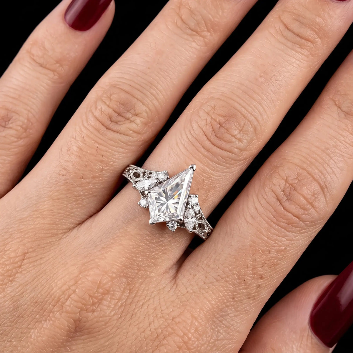 Kite cut moissanite cluster engagement ring shown on hand