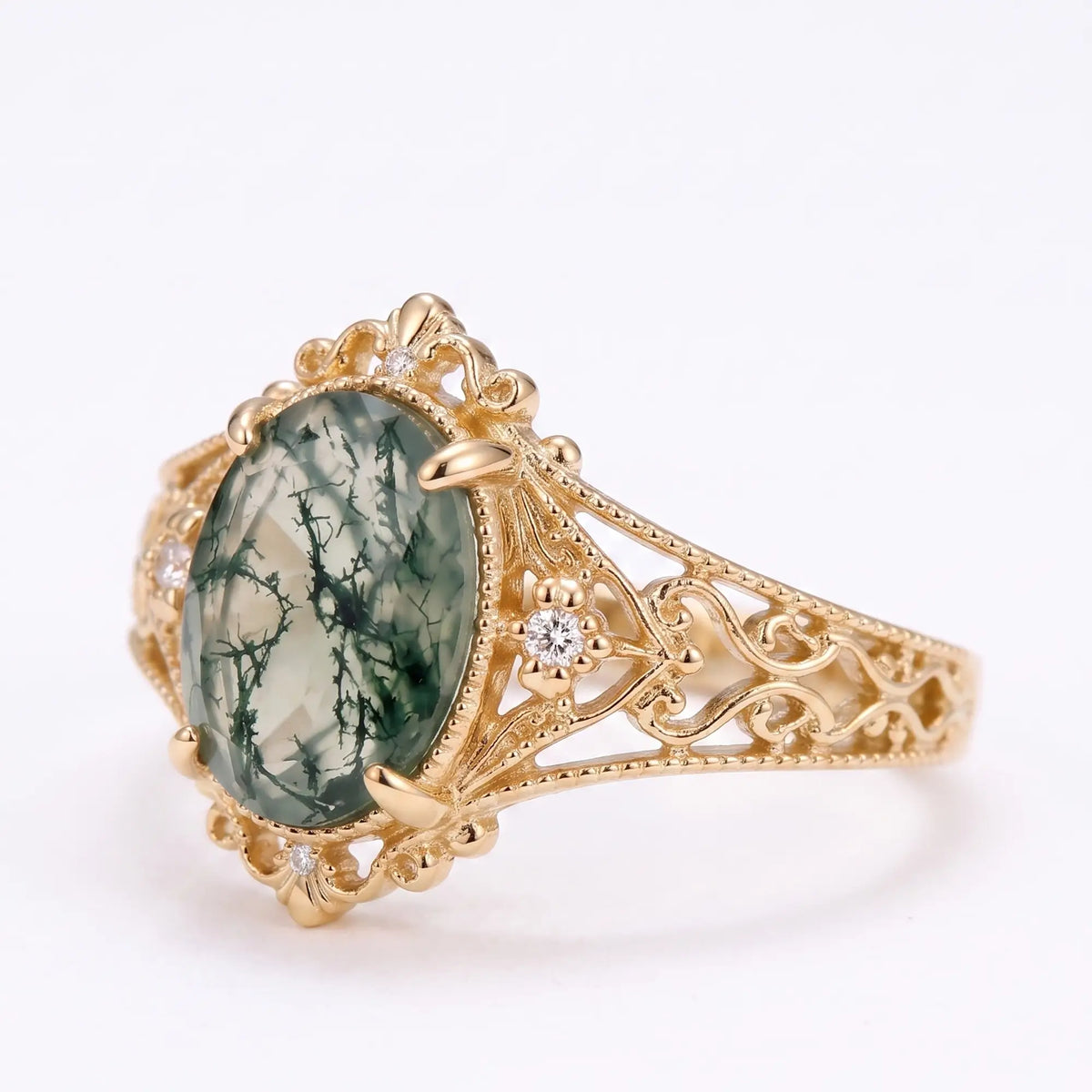 Edwardian moss agate ring with delicate openwork and scroll detailing