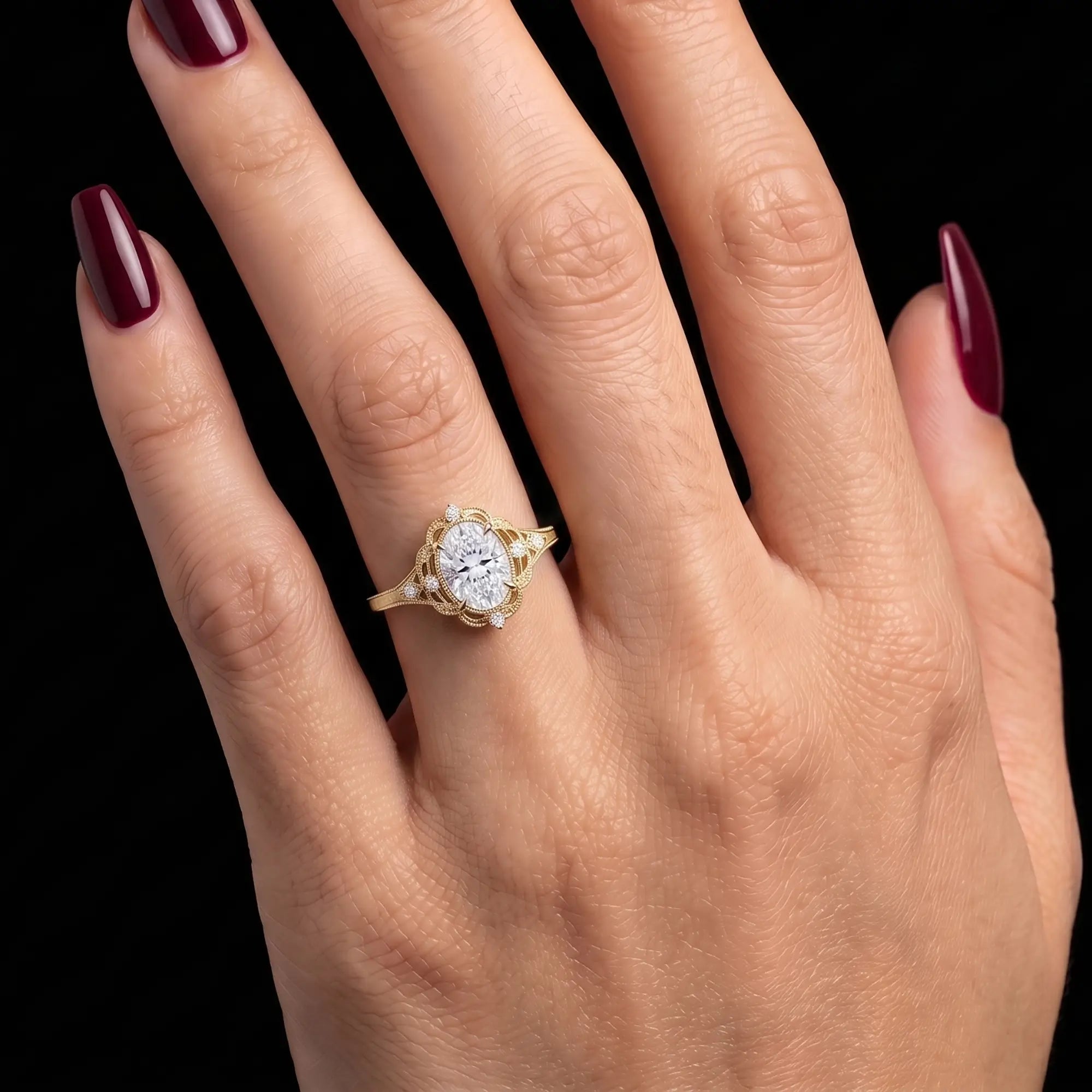 Oval moissanite filigree engagement ring worn on hand with antique inspired detailing