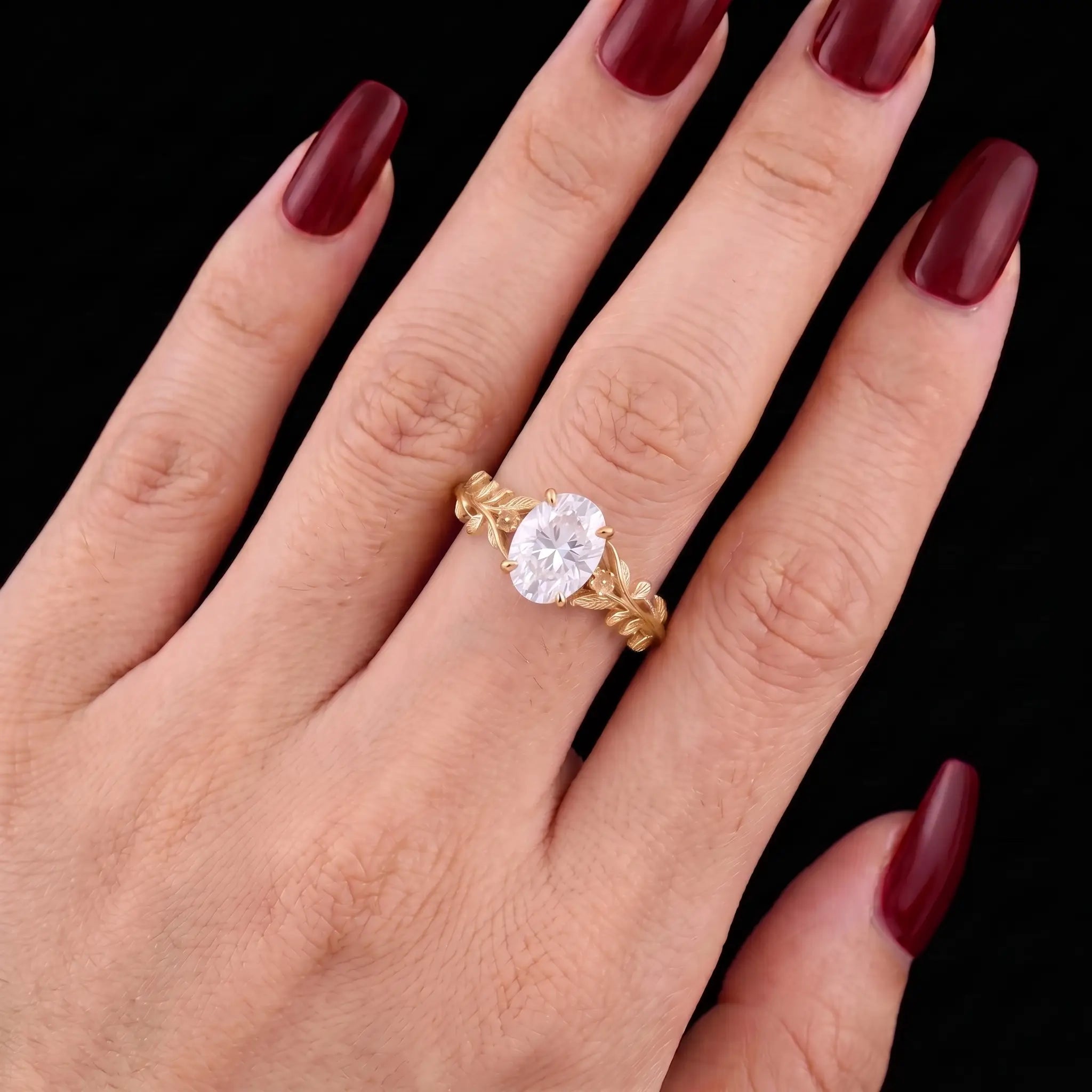 Oval moissanite botanical solitaire engagement ring worn on hand