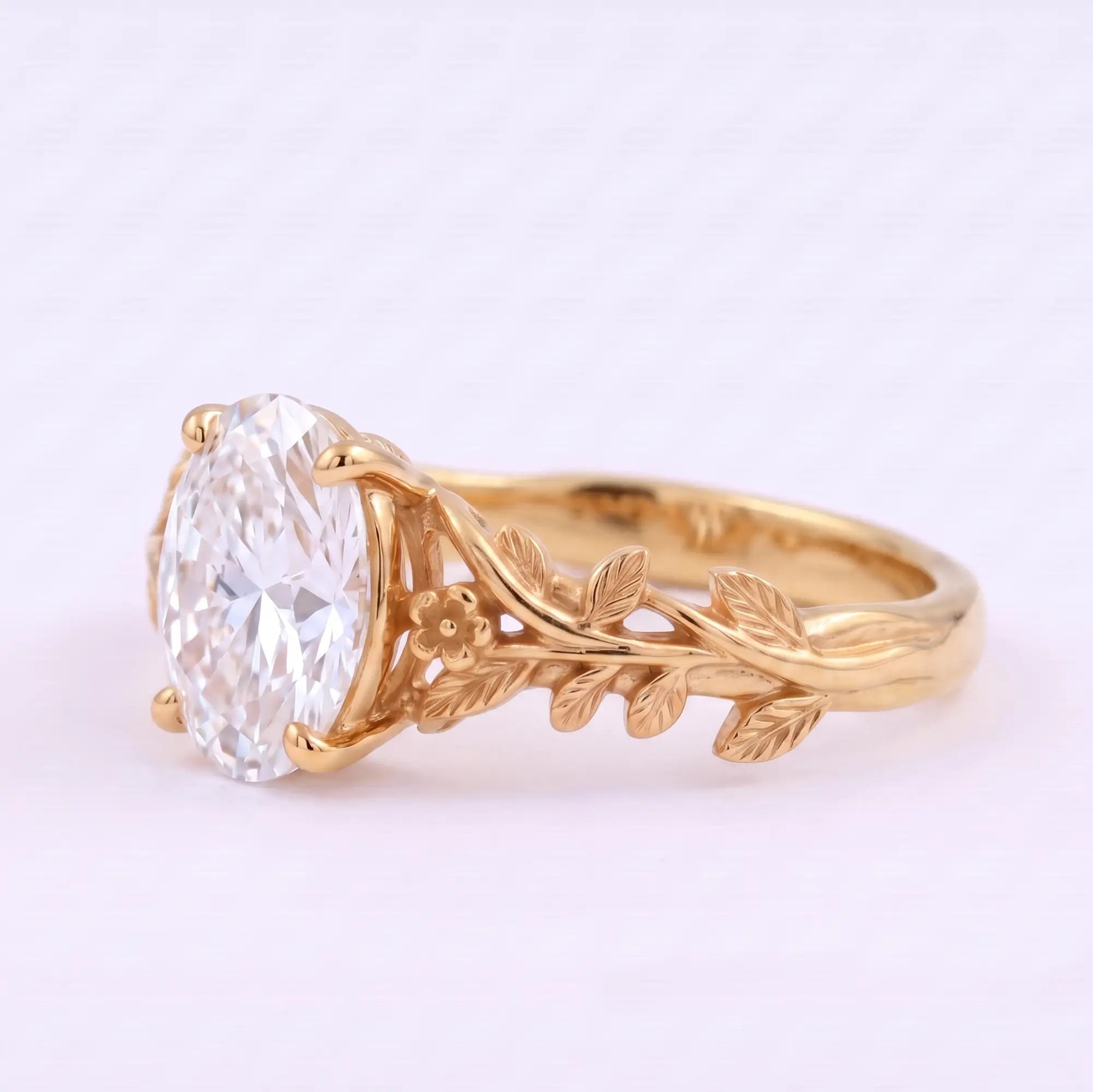 Left view of nature inspired oval moissanite ring with sculpted leaves and vines