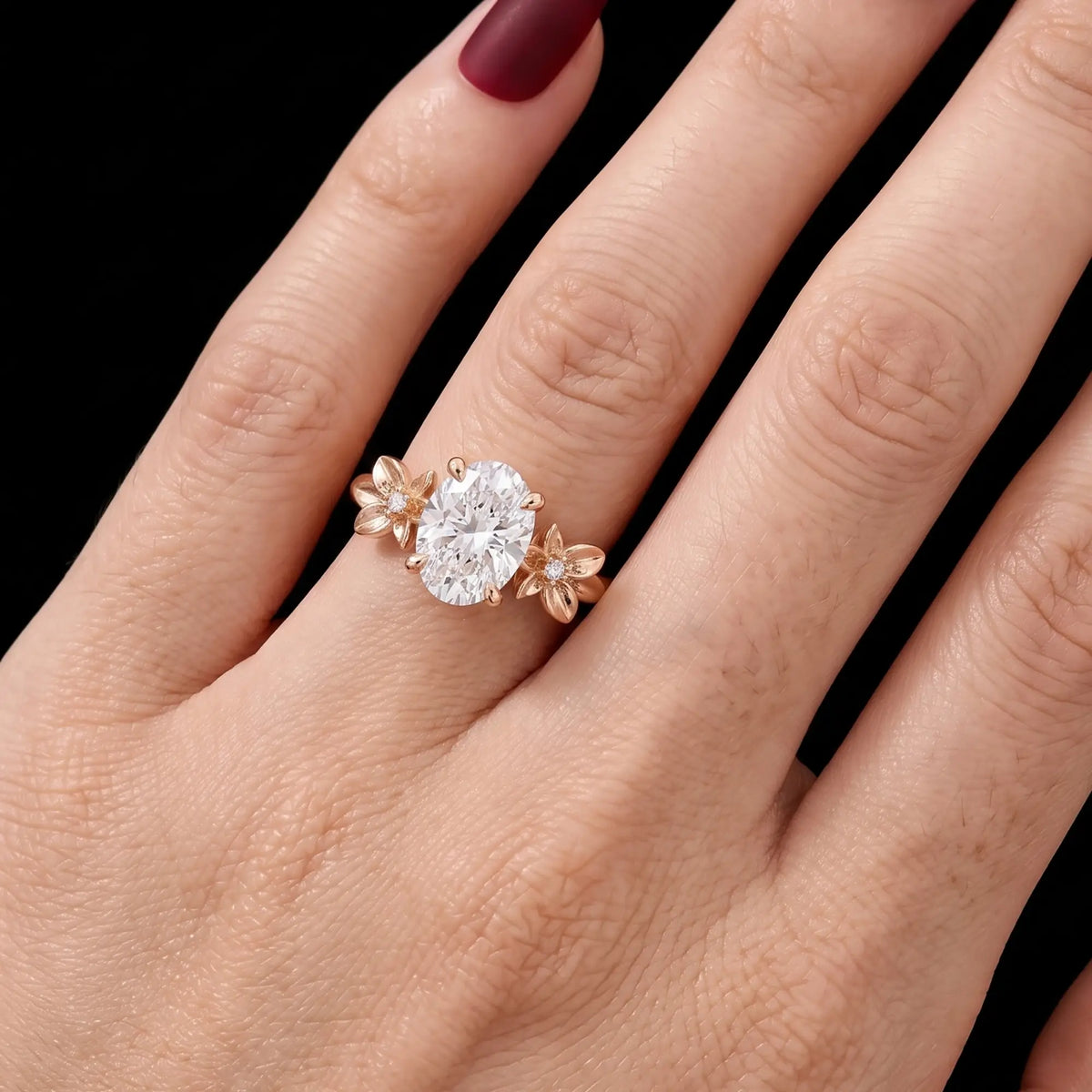 Floral three stone engagement ring worn on hand