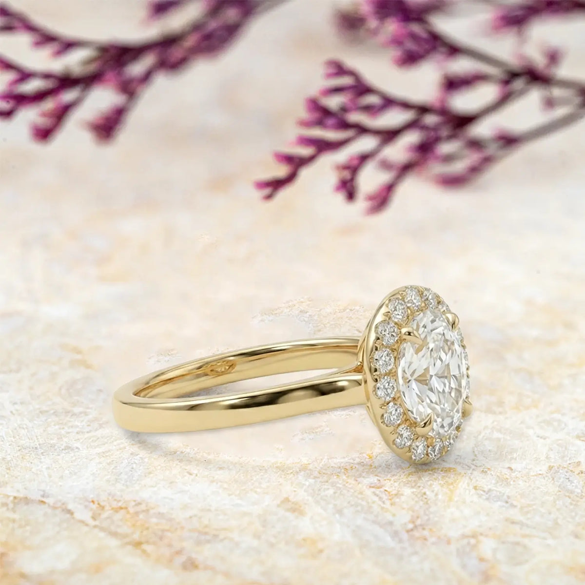 Side view of moissanite halo ring showing yellow gold band and pavé details