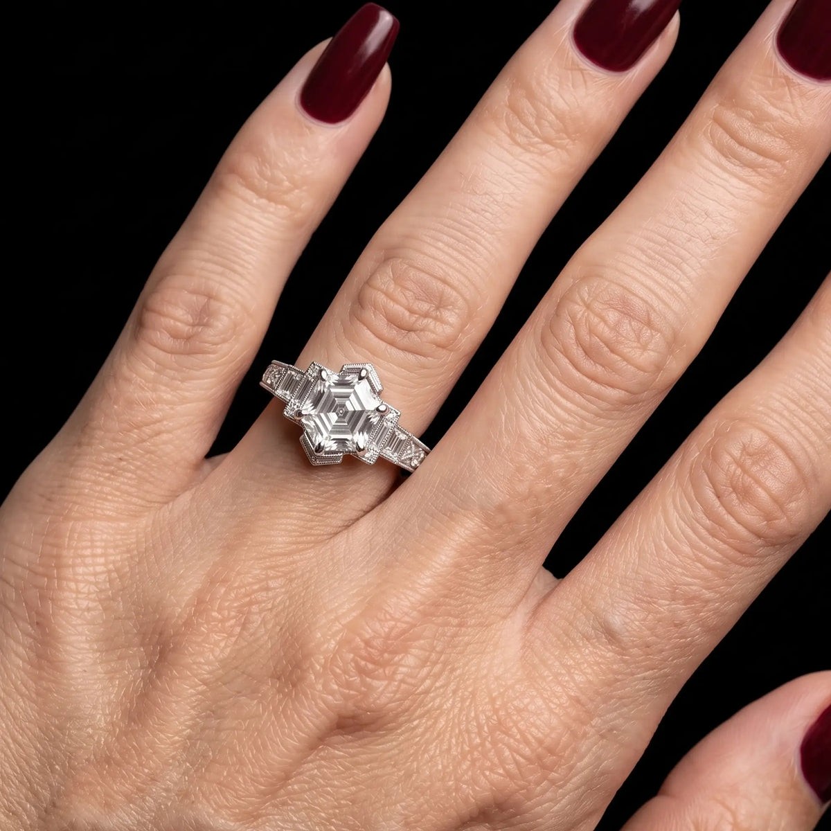Art Deco hexagon lab diamond engagement ring worn on hand with elegant geometric baguette accents