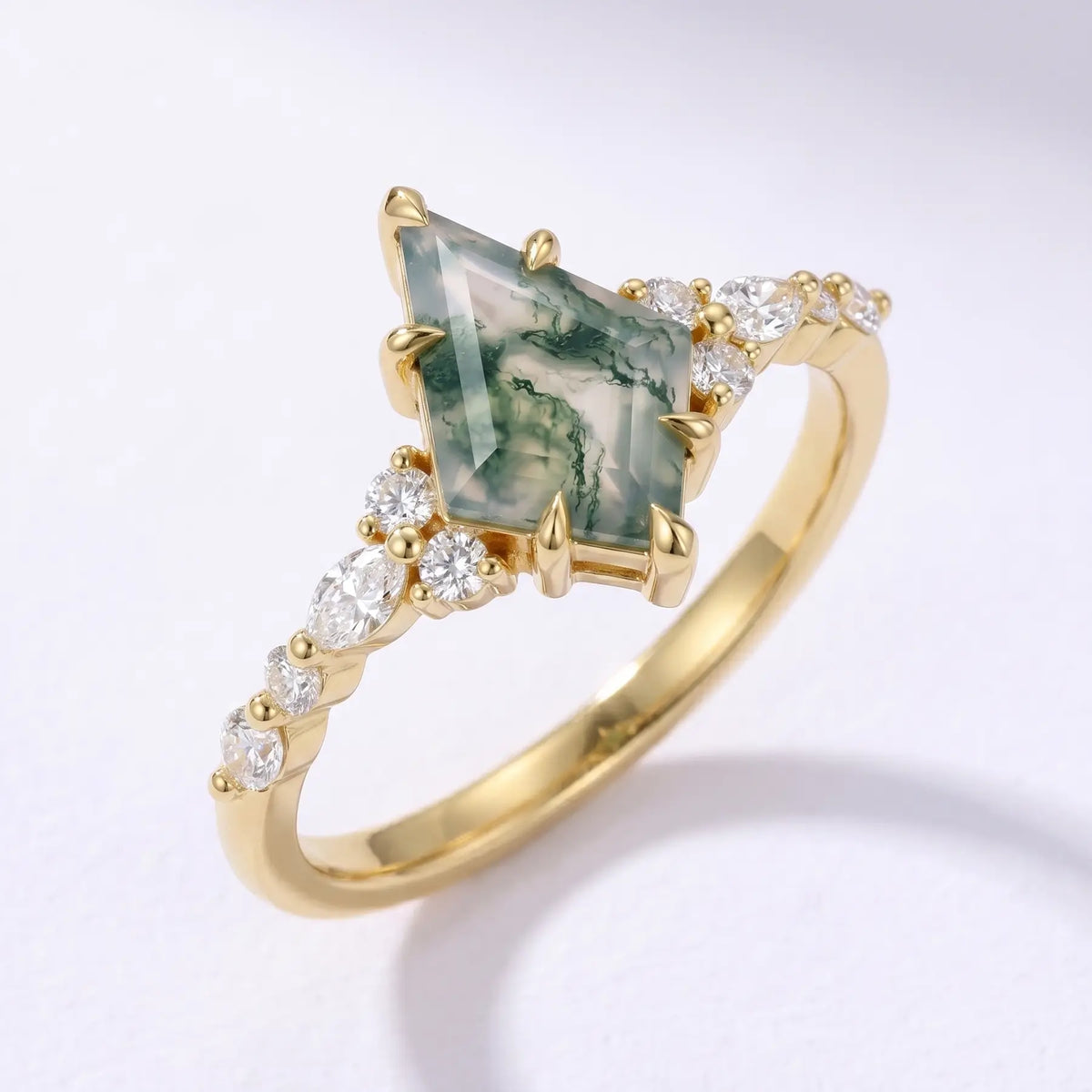 Luxury macro studio photograph of the Verdant Aura kite moss agate promise ring displayed within a soft, modern artistic setting
