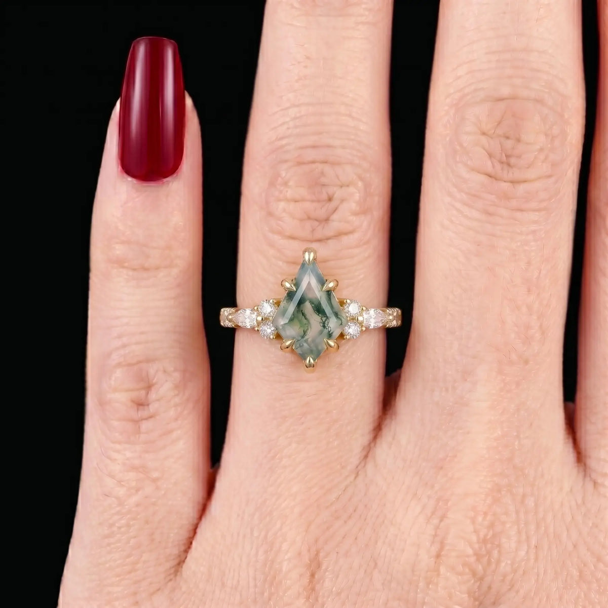 Ethereal alternative bridal kite-cut moss agate cluster ring shown on a woman's finger, demonstrating its elegant finger-elongating visual effect
