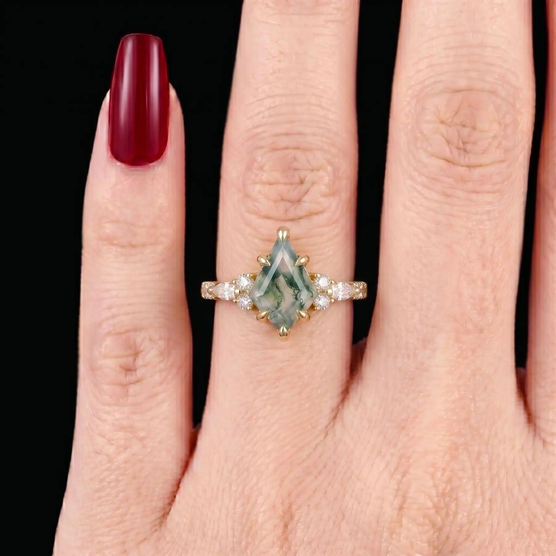 Ethereal alternative bridal kite-cut moss agate cluster ring shown on a woman's finger, demonstrating its elegant finger-elongating visual effect