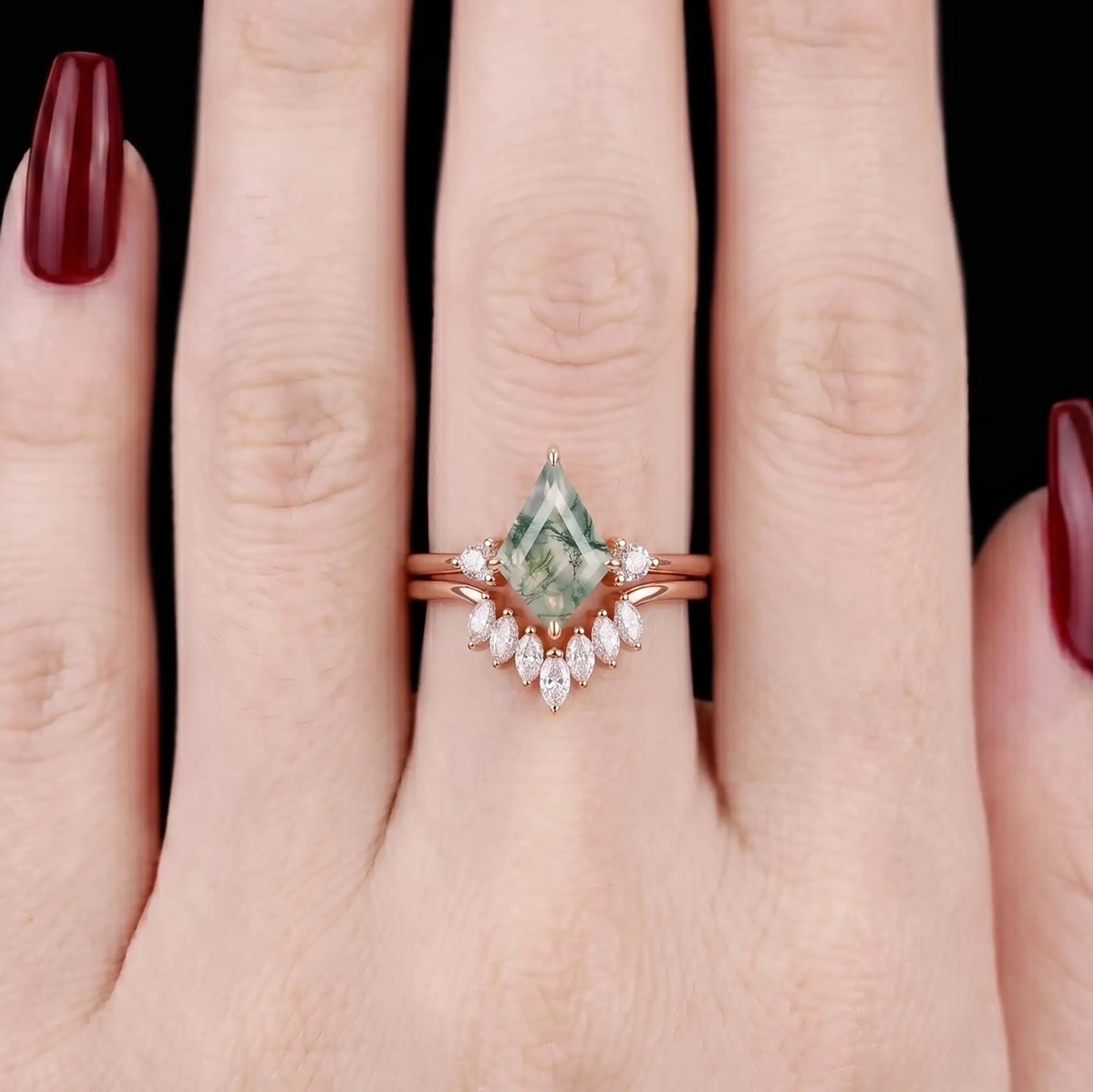 Minimalist modern kite-cut moss agate and marquise moissanite stacking bridal set shown on a finger