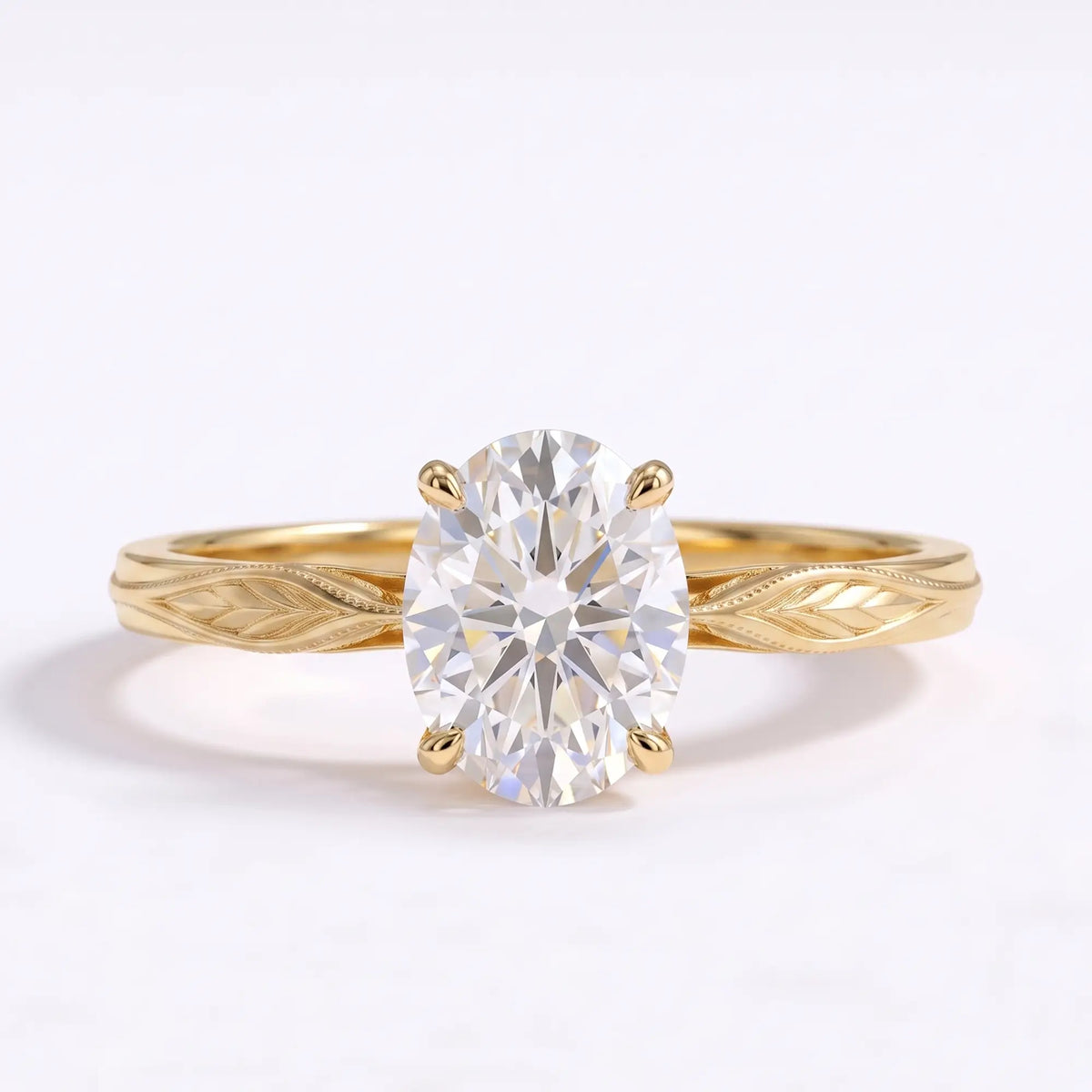 Oval lab diamond solitaire leaf engagement ring with engraved botanical band in yellow gold